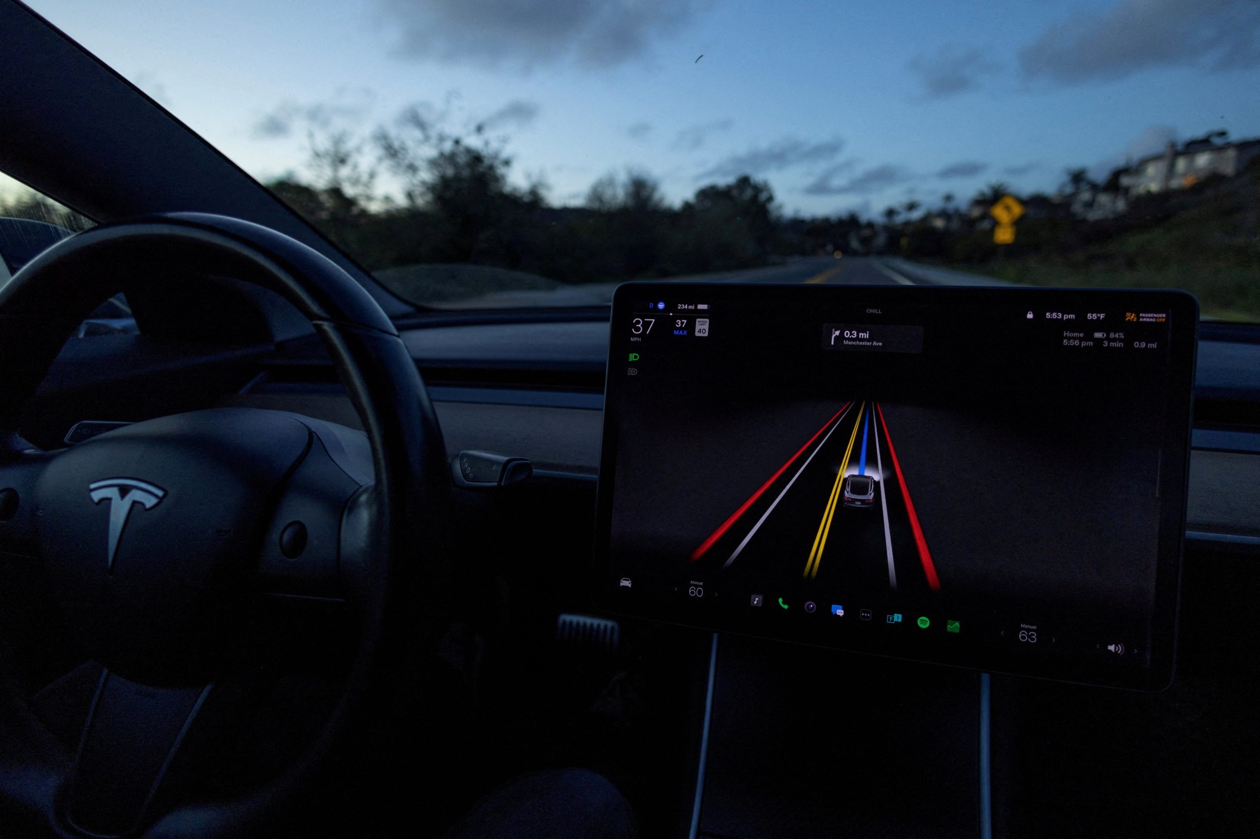 FILE PHOTO: A Tesla Model 3 vehicle is shown using the Full Self Driving Beta software (FSD) while navigating a city road in Encinitas, California, U.S., February 28, 2023. REUTERS/Mike Blake/File Photo