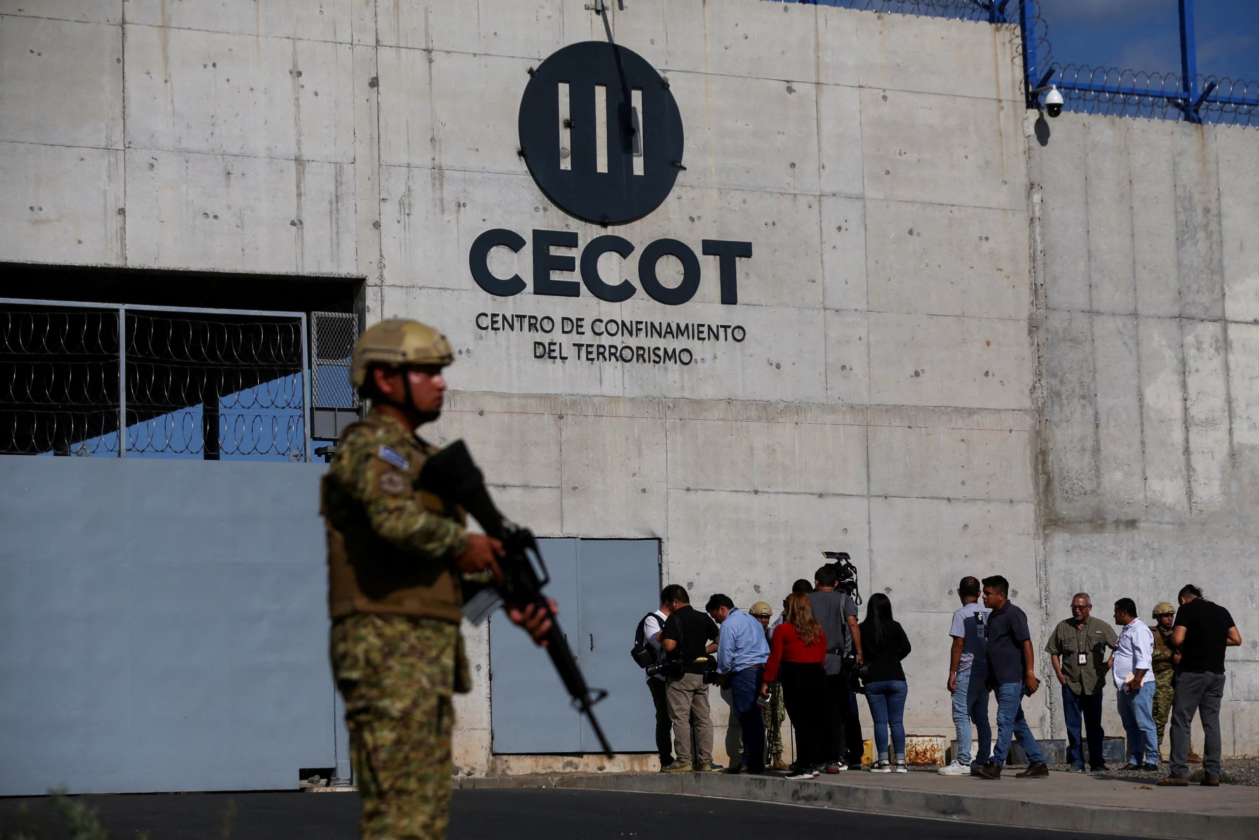 FILE PHOTO: A Salvadoran soldier stands guard, as the CECOT logo is seen, during a media tour at the Terrorism Confinement Center (CECOT) prison, in Tecoluca, El Salvador April 4, 2025. REUTERS/Jose Cabezas/File Photo