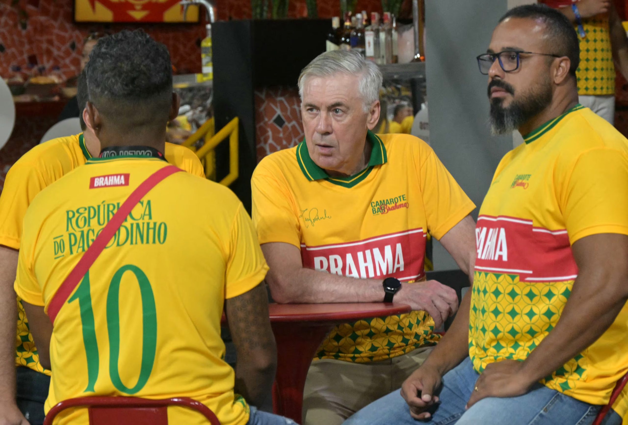 El entrenador italiano de Brasil, Carlo Ancelotti (centro), se sienta en una zona VIP durante la segunda noche del desfile de carnaval en el Sambódromo de Sao Paulo, Brasil (Foto de NELSON ALMEIDA / AFP)