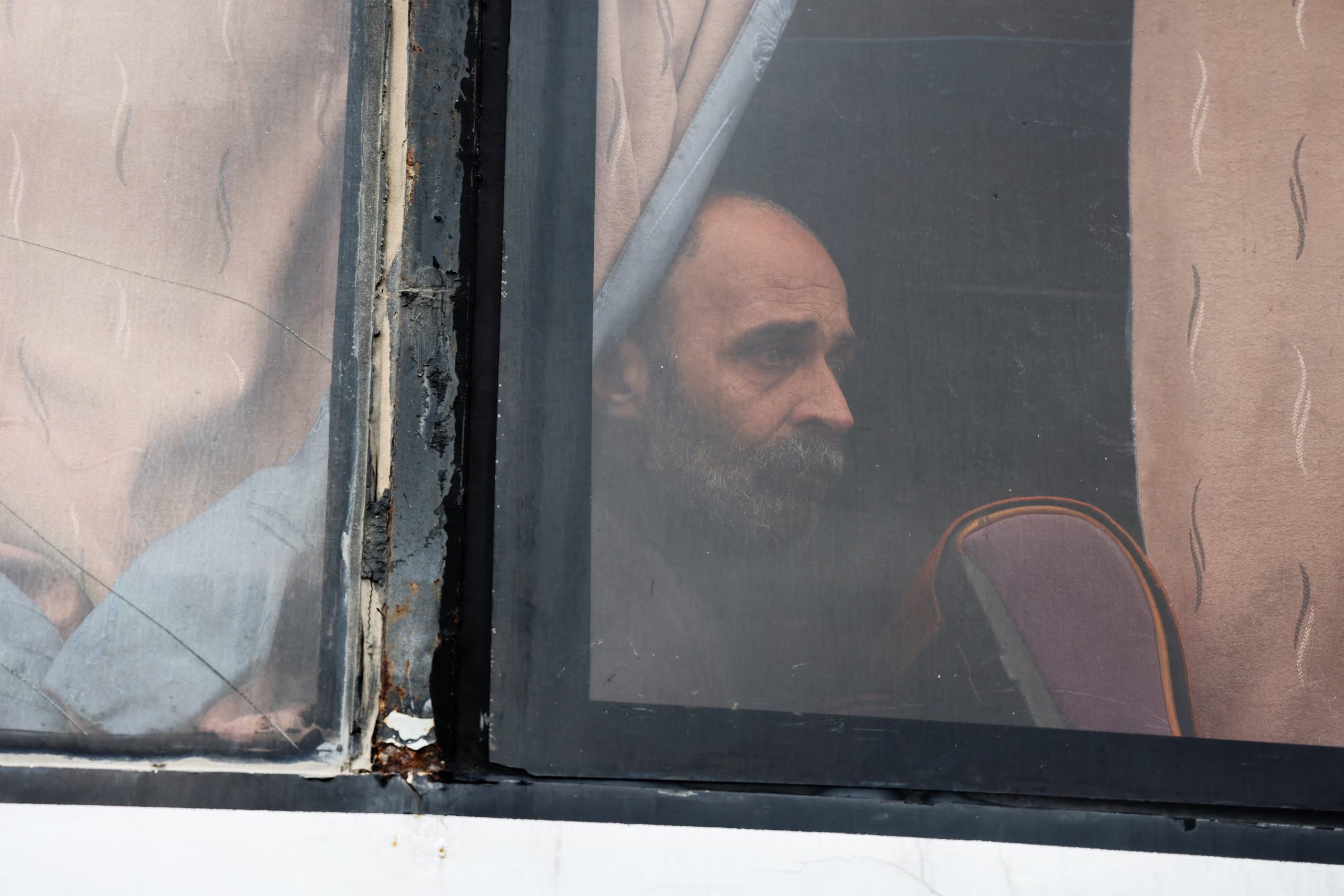 Un detenido recientemente liberado se sienta dentro de un autobús durante una operación de intercambio de prisioneros entre el gobierno sirio y facciones drusas, en Sweida, Siria, el 26 de febrero de 2026. REUTERS/Omar Alwan