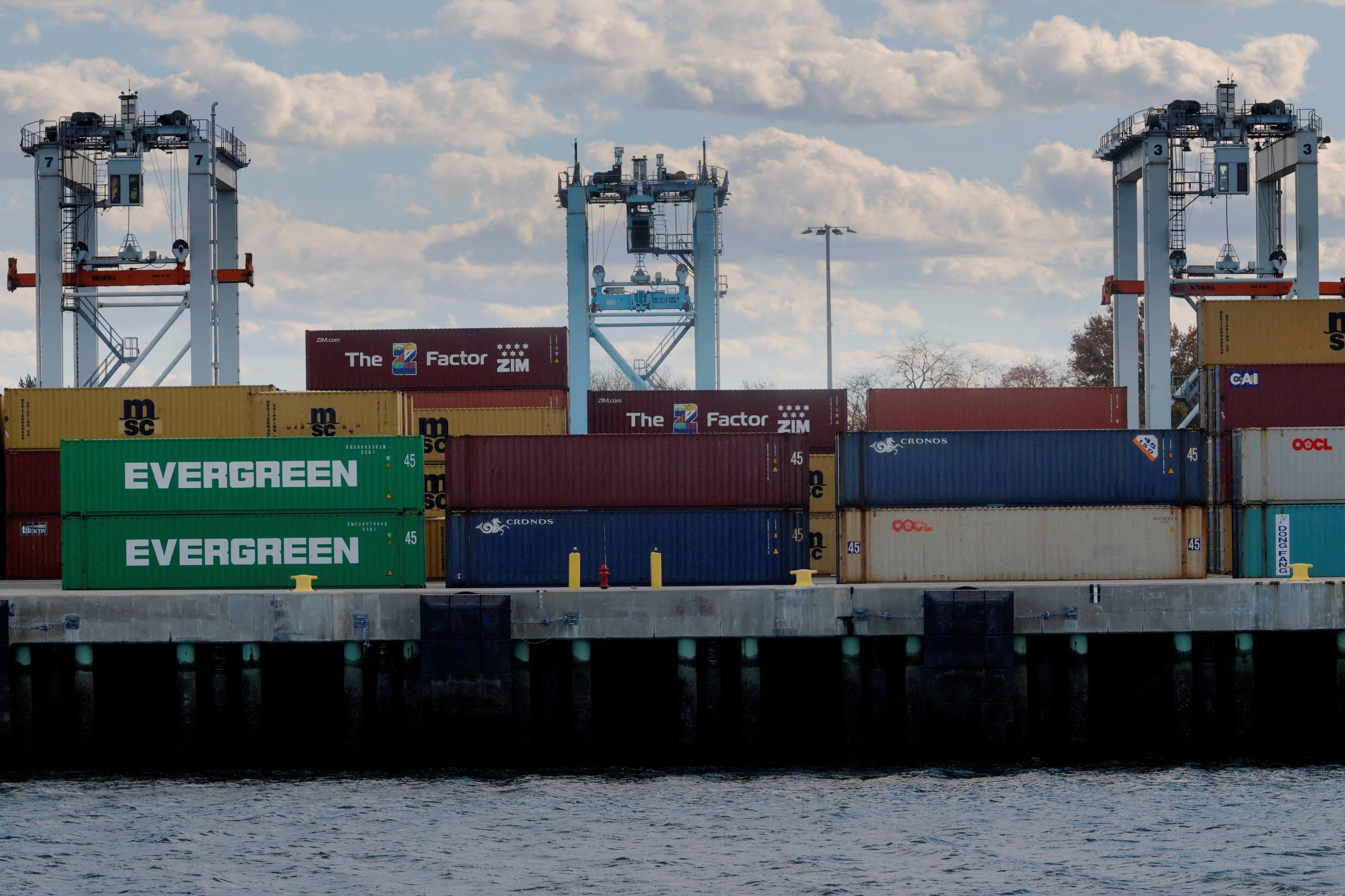 Cranes stand over stacked shipping containers at the Conley Container Terminal, as the U.S. Supreme Court is set to consider the legality of U.S. President Donald Trump's global tariffs, in Boston, Massachusetts, U.S., November 4, 2025. REUTERS/Brian Snyder