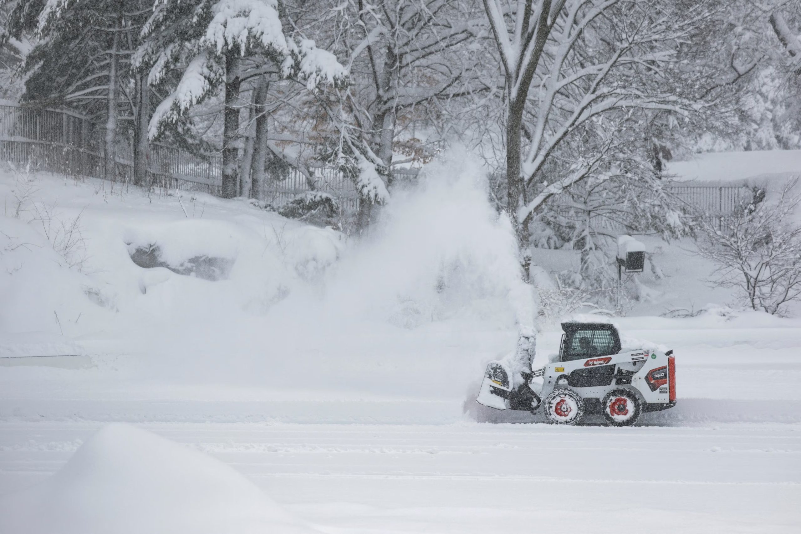 A snowplow clears the road in Central Park as snow falls during a winter storm in New York City, U.S., February 23, 2026. REUTERS/Jeenah Moon