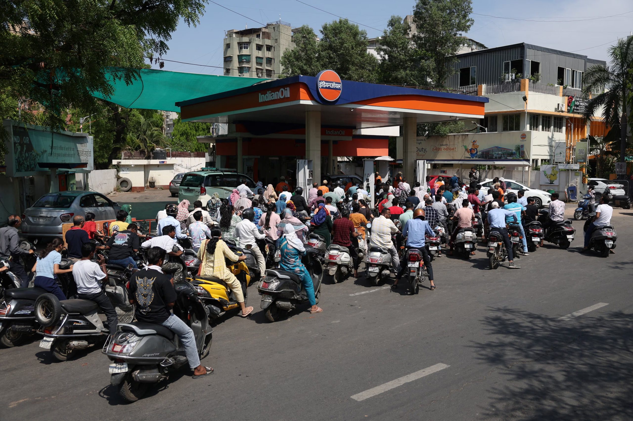 El lunes, varias personas hacían cola para repostar en una gasolinera de Ahmedabad, en la India (REUTERS)