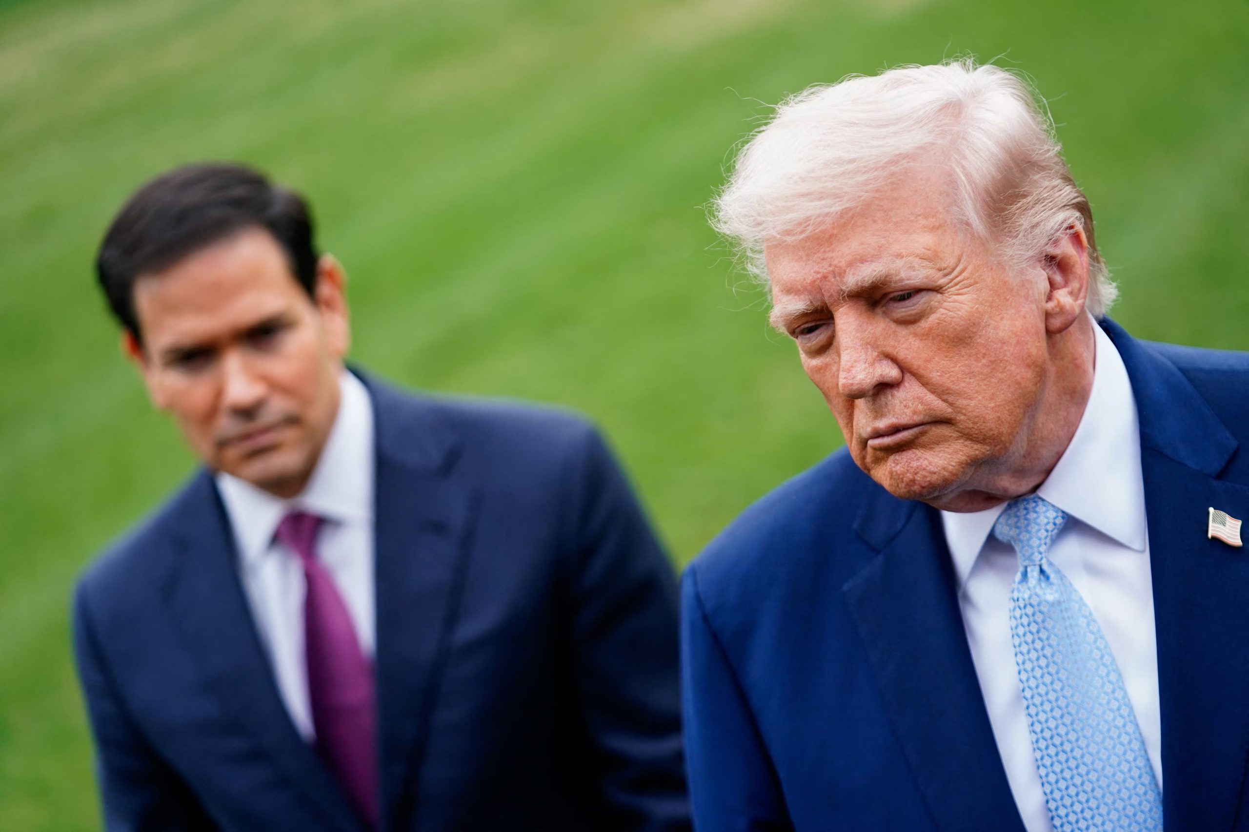U.S. President Donald Trump speaks to the media, flanked by U.S. Secretary of State Marco Rubio, as he departs the White House for Florida, in Washington, D.C., U.S., March 20, 2026. REUTERS/Nathan Howard
