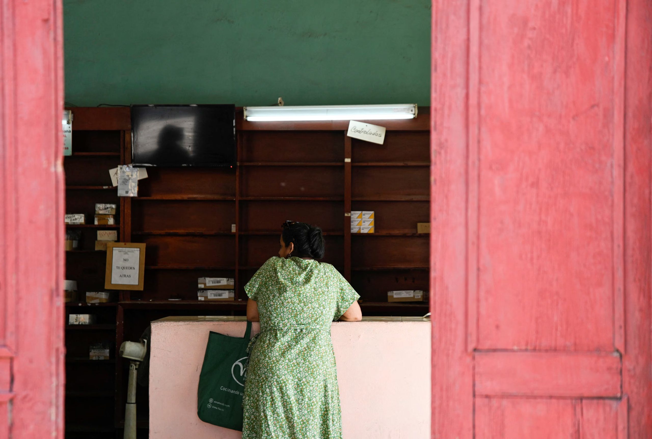 A customer waits inside a pharmacy, as Cuba’s once-vaunted healthcare system, long hailed as a cornerstone of the 1959 revolution, has deteriorated amid years of economic crisis and U.S. sanctions, a decline that has accelerated this year with U.S. restrictions on oil supplies, in Havana, Cuba, March 24, 2026. REUTERS/Norlys Perez