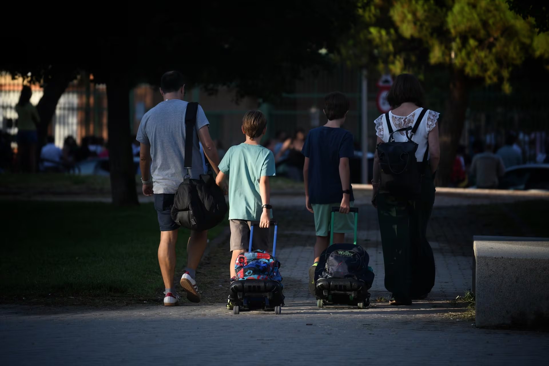 Dos niños pasean junto a sus padres a la salida del colegio. (Fernando Sánchez / Europa Press)