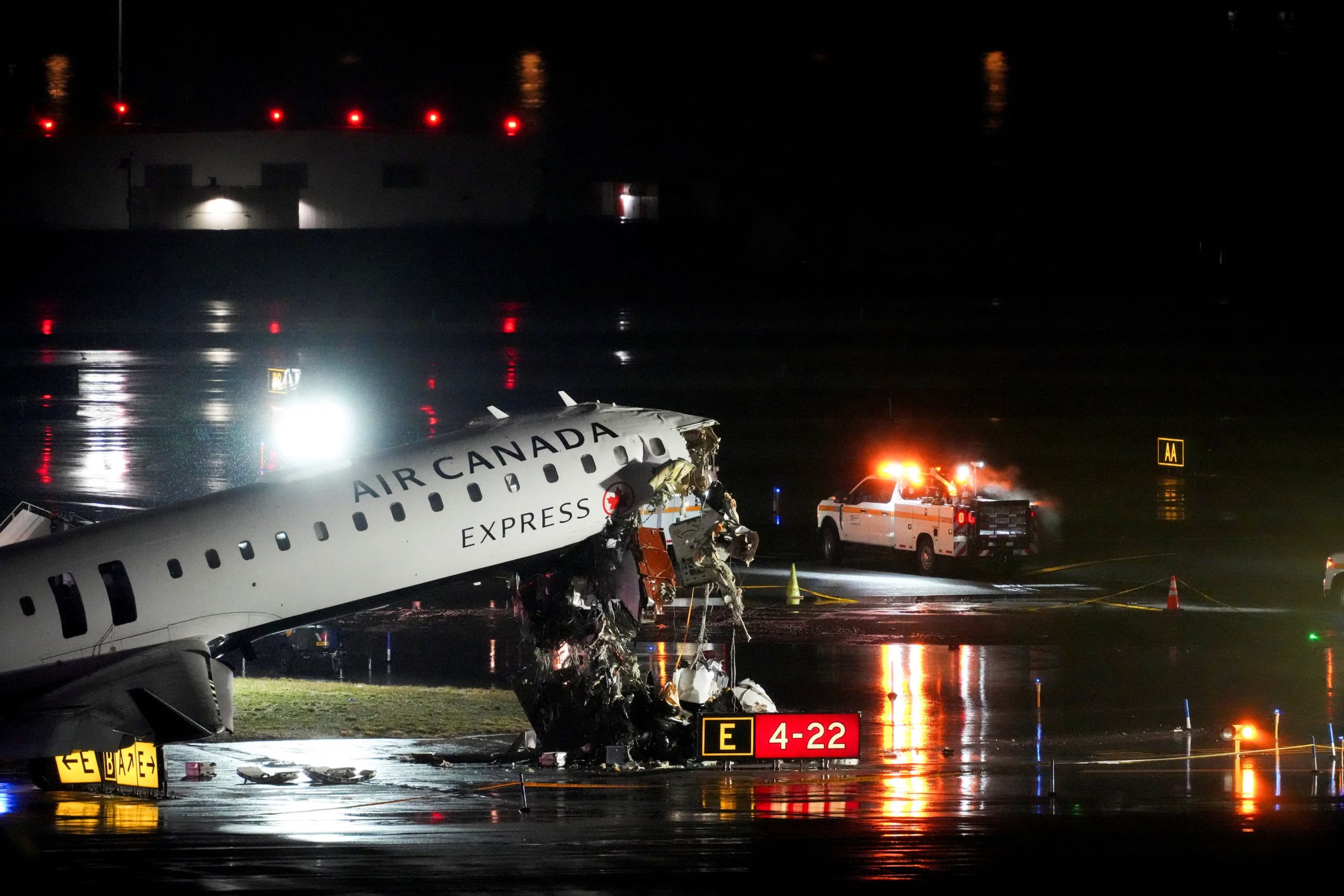 Debris hangs from a damaged Air Canada Express jet that had collided with a fire truck at New York's LaGuardia Airport in Queens, New York, U.S., March 23, 2026. REUTERS/Adam Gray