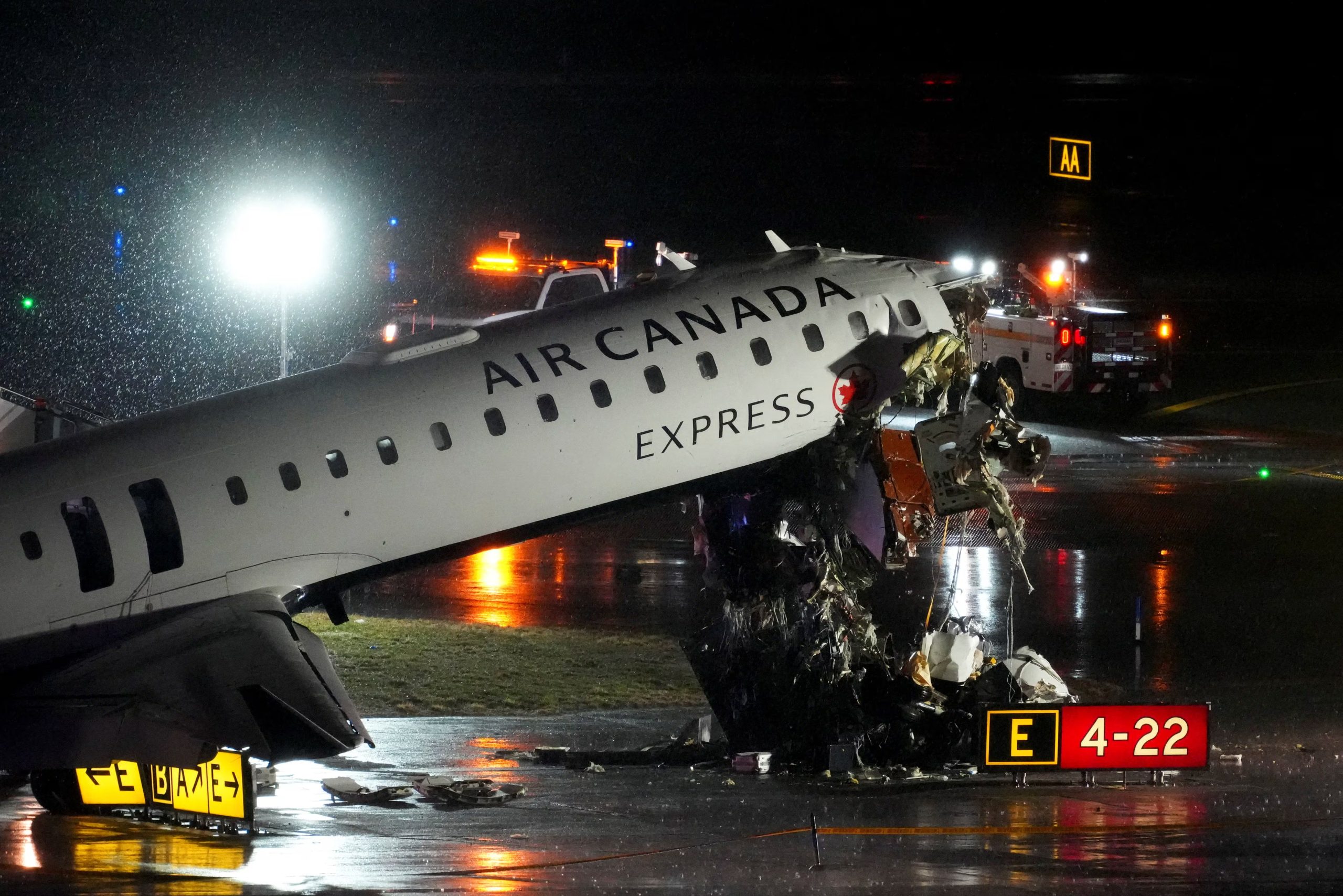Debris hangs from a damaged Air Canada Express jet that had collided with a fire truck at New York's LaGuardia Airport in Queens, New York, U.S., March 23, 2026. REUTERS/Adam Gray