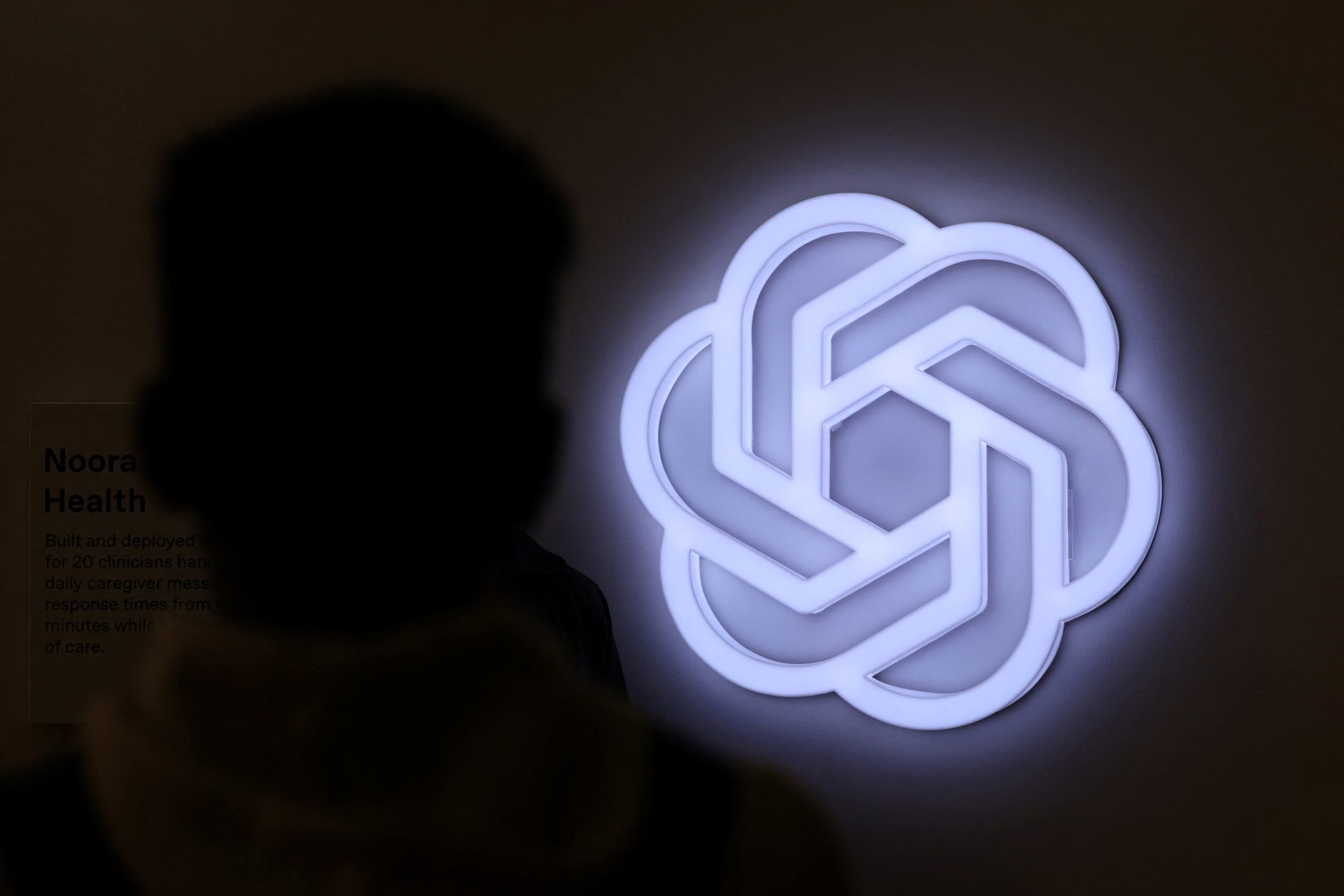 A person stands next to the logo of ChatGPT, an AI-powered chatbot by OpenAI at Bharat Mandapam, one of the venues for AI Impact Summit, in New Delhi, India, February 17, 2026. REUTERS/Bhawika Chhabra