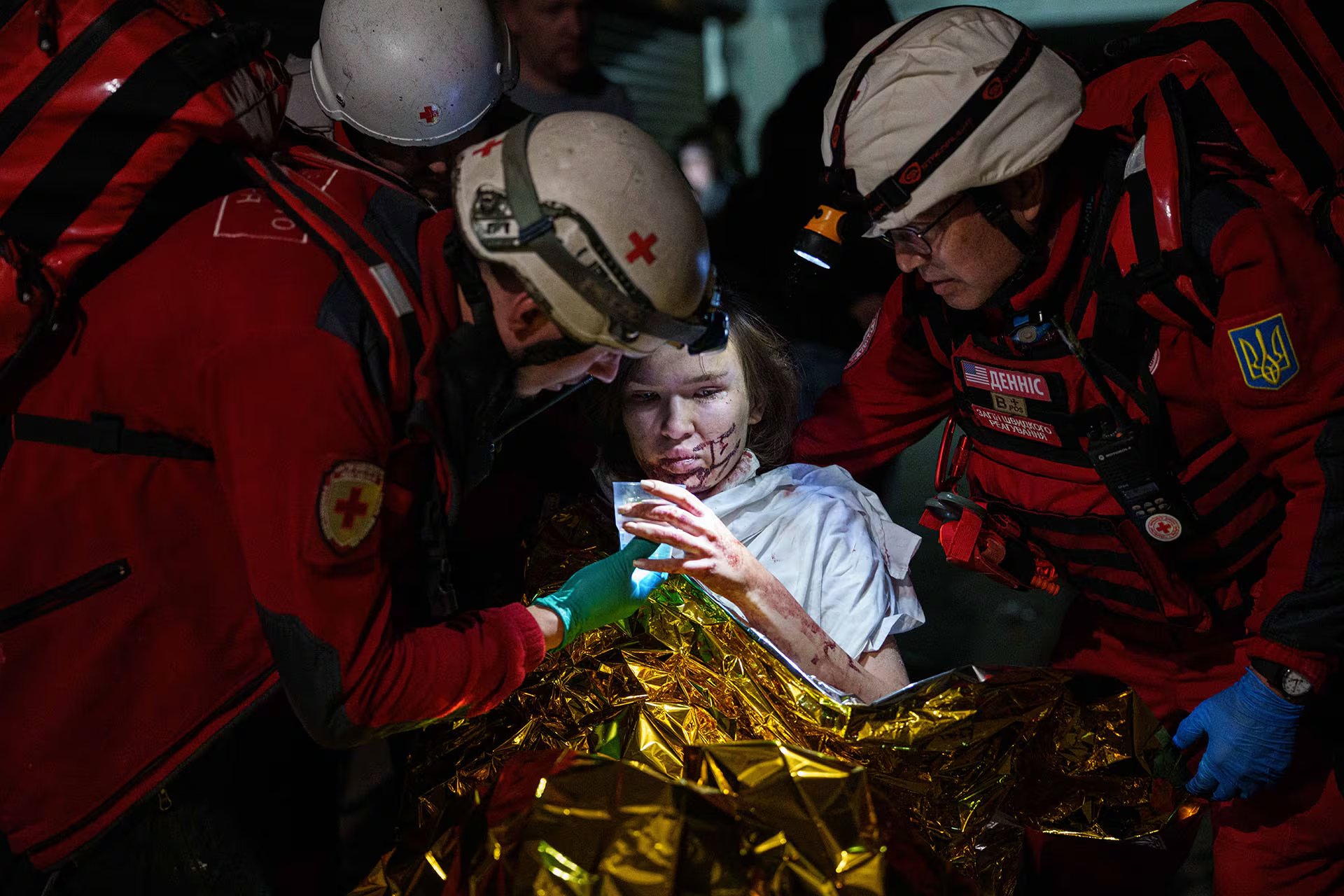 Una mujer herida tras un ataque ruso con misiles en Ucrania es atendida por socorristas de emergencia, en un momento de cautela internacional hacia Bielorrusia.