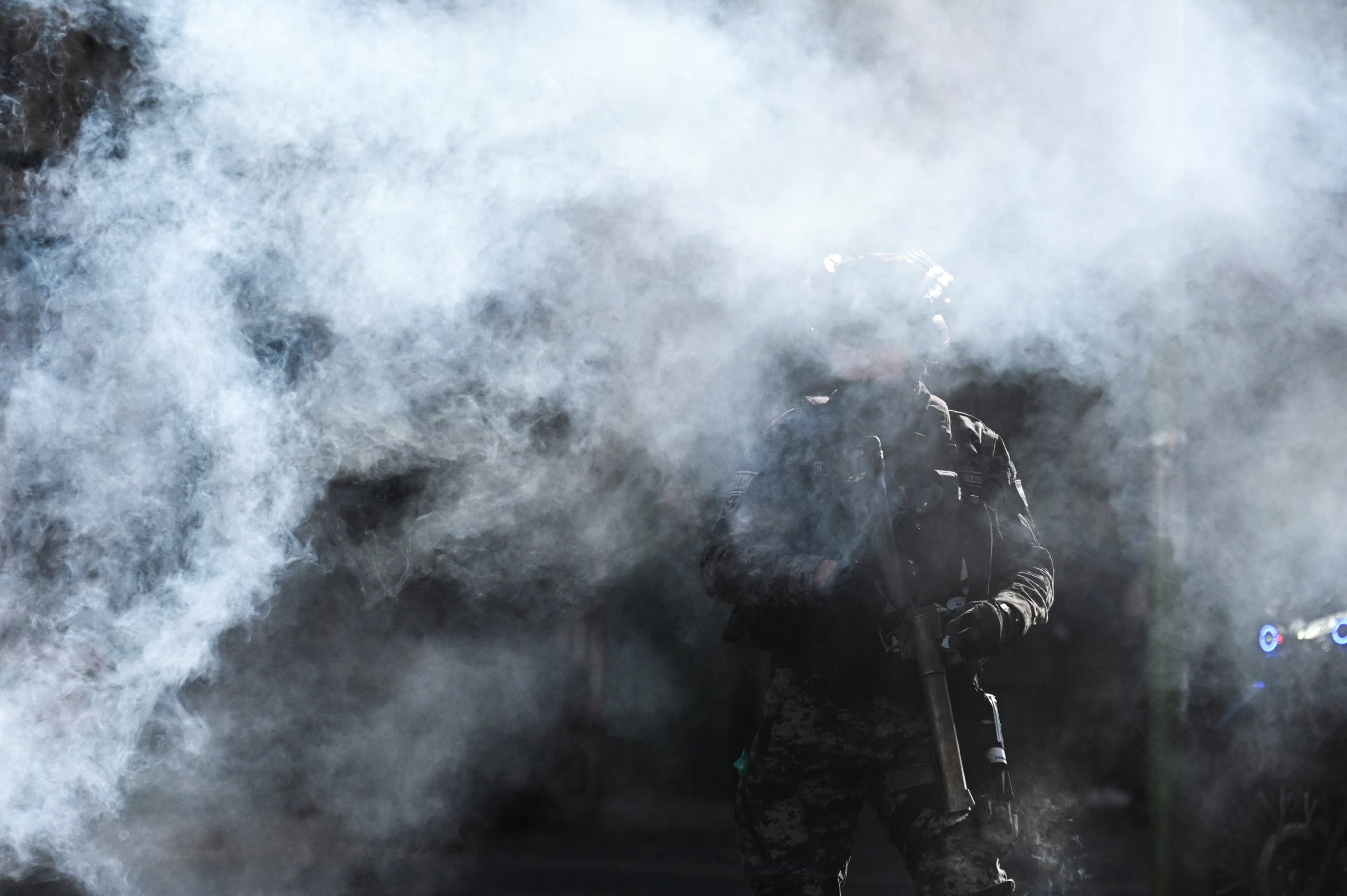 A riot police officer stands amid tear gas during a protest against President Rodrigo Paz's government amid an ongoing economic and fuel crisis, in La Paz, Bolivia, May 14, 2026. REUTERS/Claudia Morales