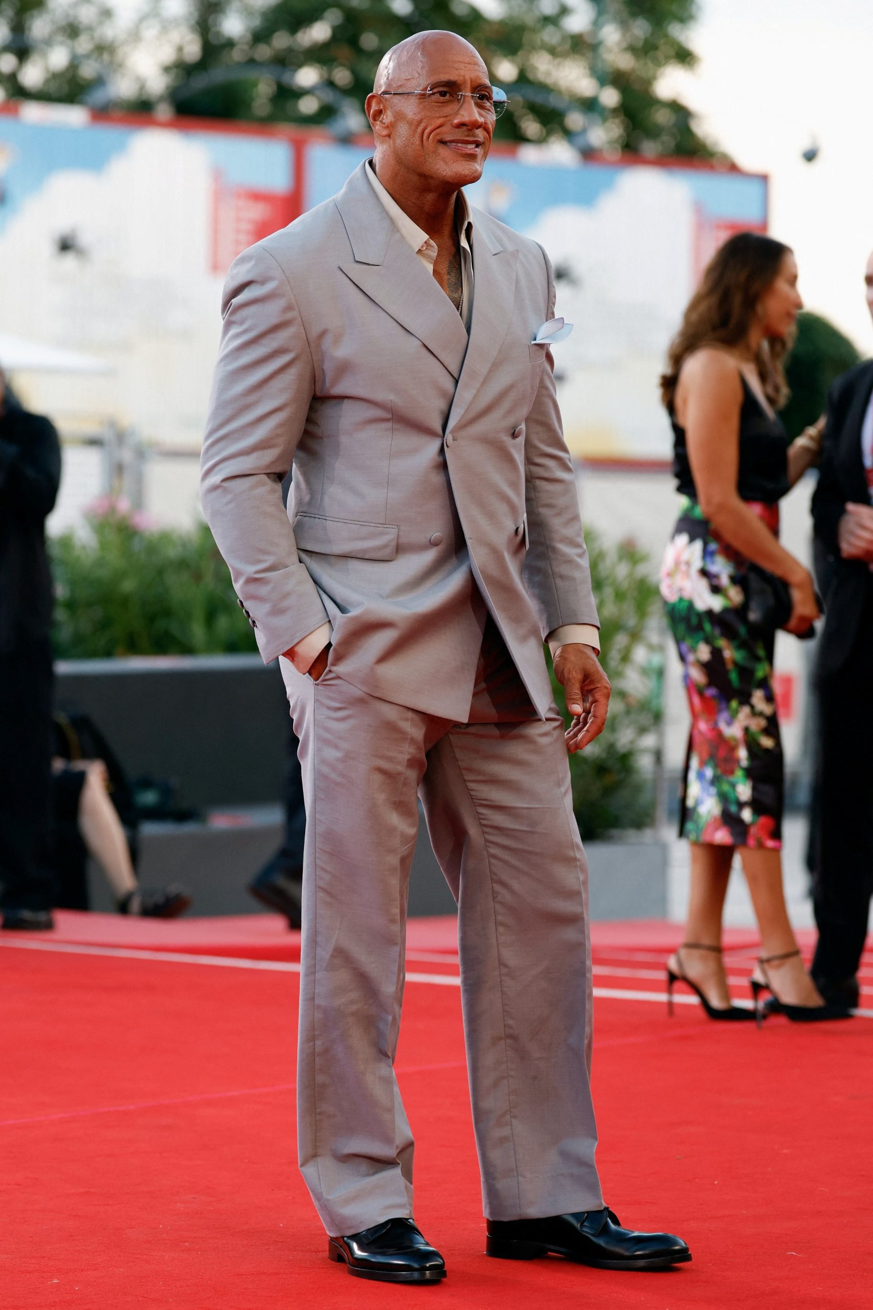 La doble botonadura en tono arena y los accesorios celestes confirman la preferencia de Dwayne Johnson por la elegancia fresca y contemporánea (REUTERS/Remo Casilli)