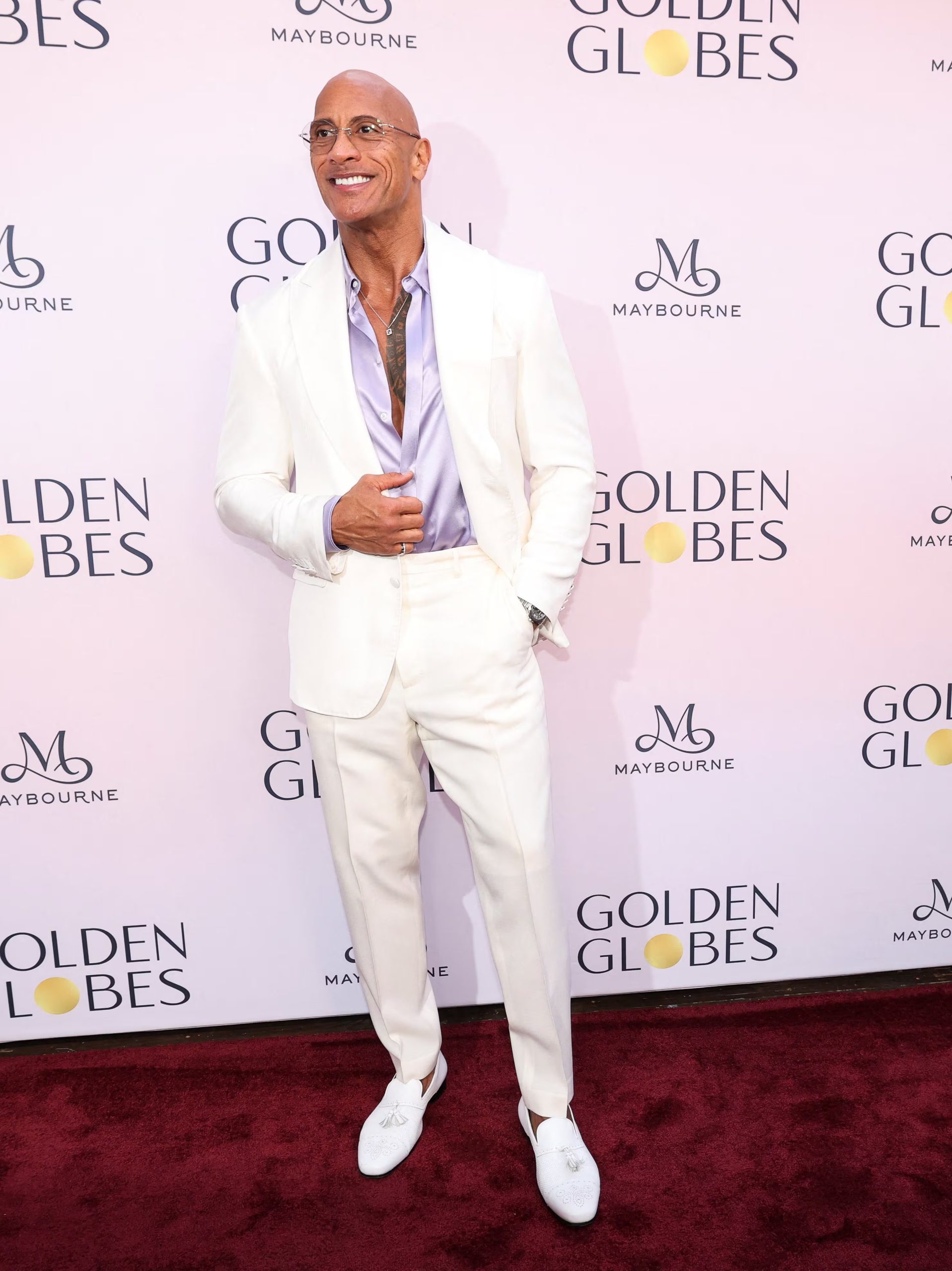 El traje blanco y la camisa lavanda abierta muestran el atrevimiento cromático y el toque moderno que define a Dwayne Johnson en las alfombras rojas (REUTERS/Mario Anzuoni)