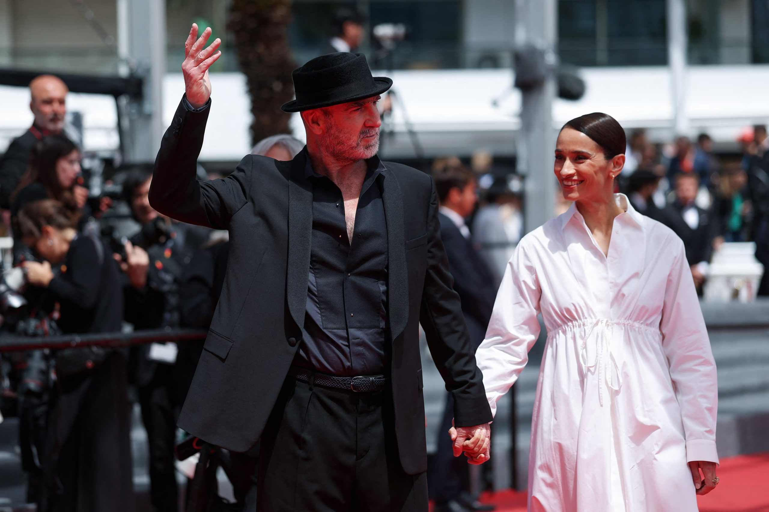 Eric Cantona and Rachida Brakni pose on the red carpet during arrivals for the screening of the film 