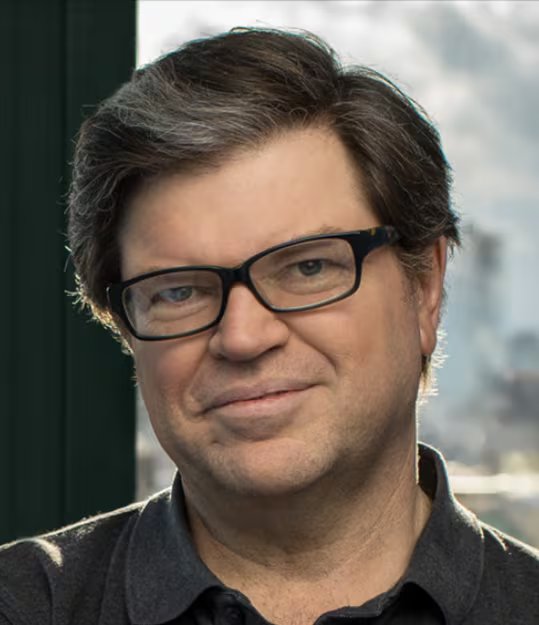 El científico informático Yeann LeCun, una voz destacada en el campo de la inteligencia artificial, posa sonriendo con gafas en un entorno interior bien iluminado.
