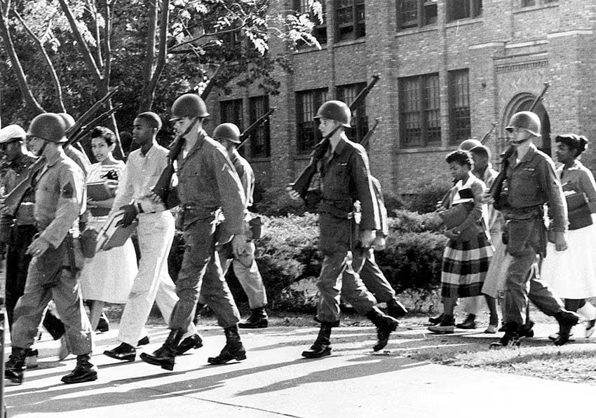Tropas de la 101ª División Aerotransportada escoltan a los “Little Rock Nine” en Arkansas (1957). El gobierno federal usó la fuerza militar para garantizar el fallo de integración escolar en EE.UU.
