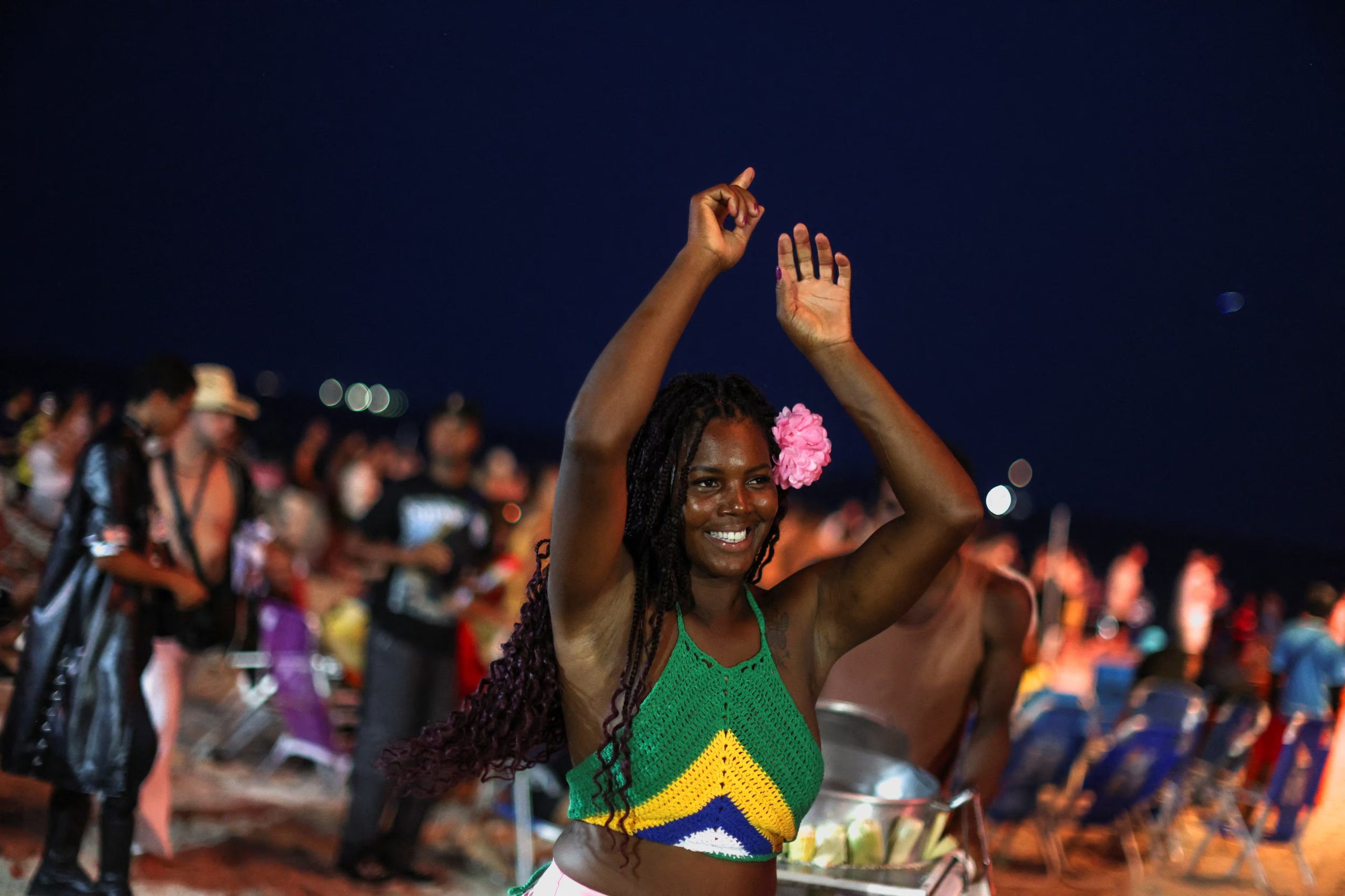 A fan dances as she and others gather at Copacabana beach ahead of Shakira's open concert in Rio de Janeiro, Brazil, May 2, 2026. REUTERS/Pilar Olivares