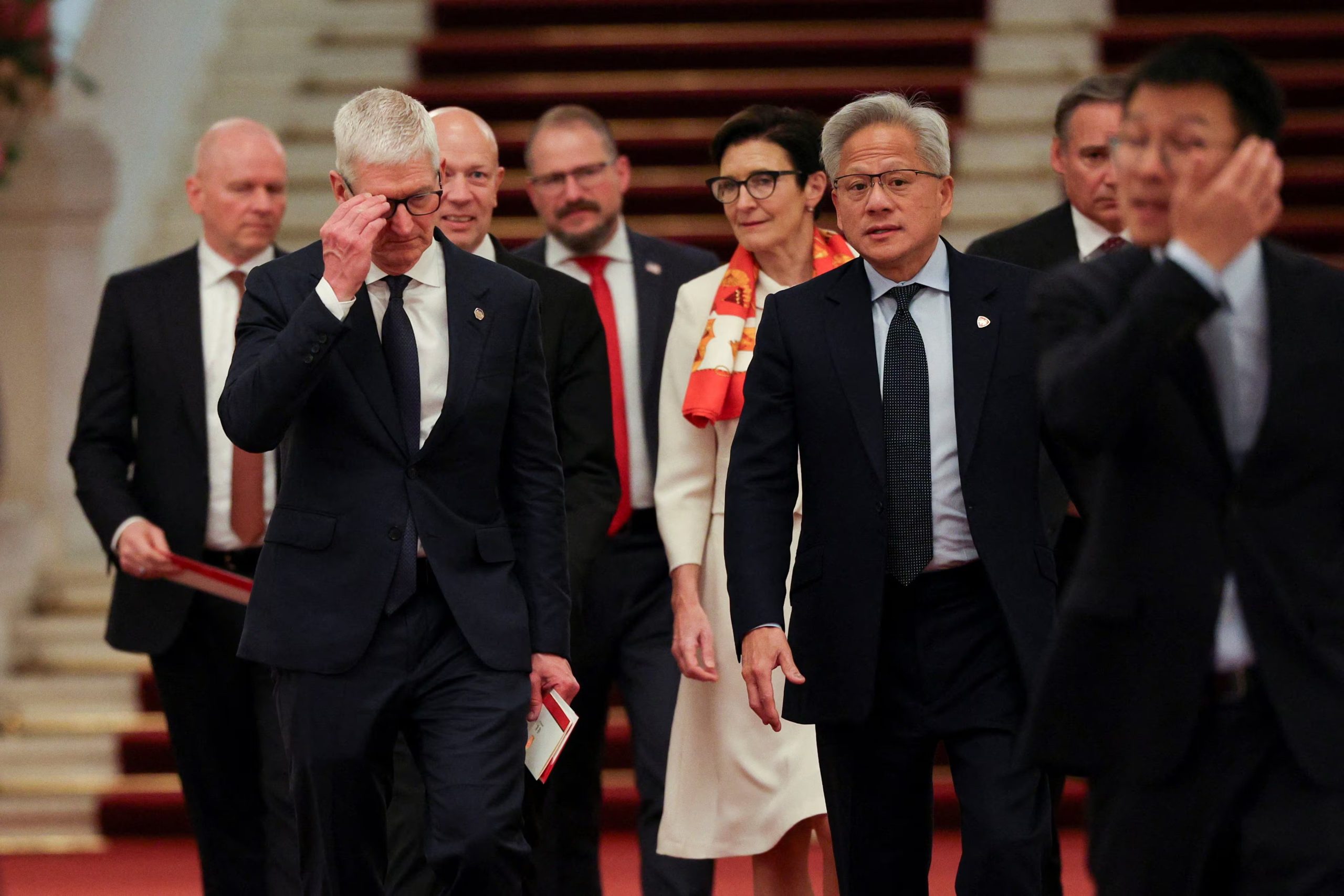Nvidia CEO Jensen Huang, Apple CEO Tim Cook and Citi CEO Jane Fraser arrive for the meeting between Chinese Premier Li Qiang and U.S. business representatives, at the Great Hall of the People in Beijing, China May 14, 2026. REUTERS/Go Nakamura/Pool