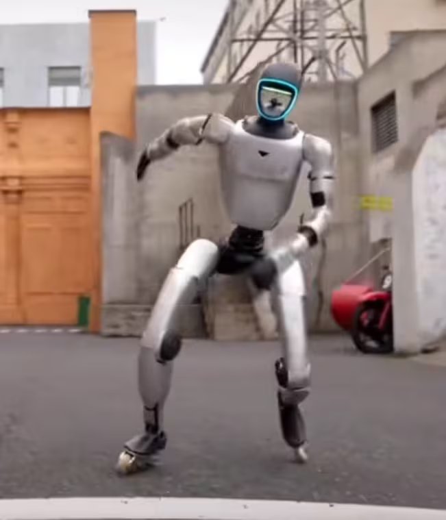 Un robot humanoide de aspecto moderno realiza una coreografía de baile en un callejón urbano, mostrando avanzadas capacidades de movimiento y agilidad.