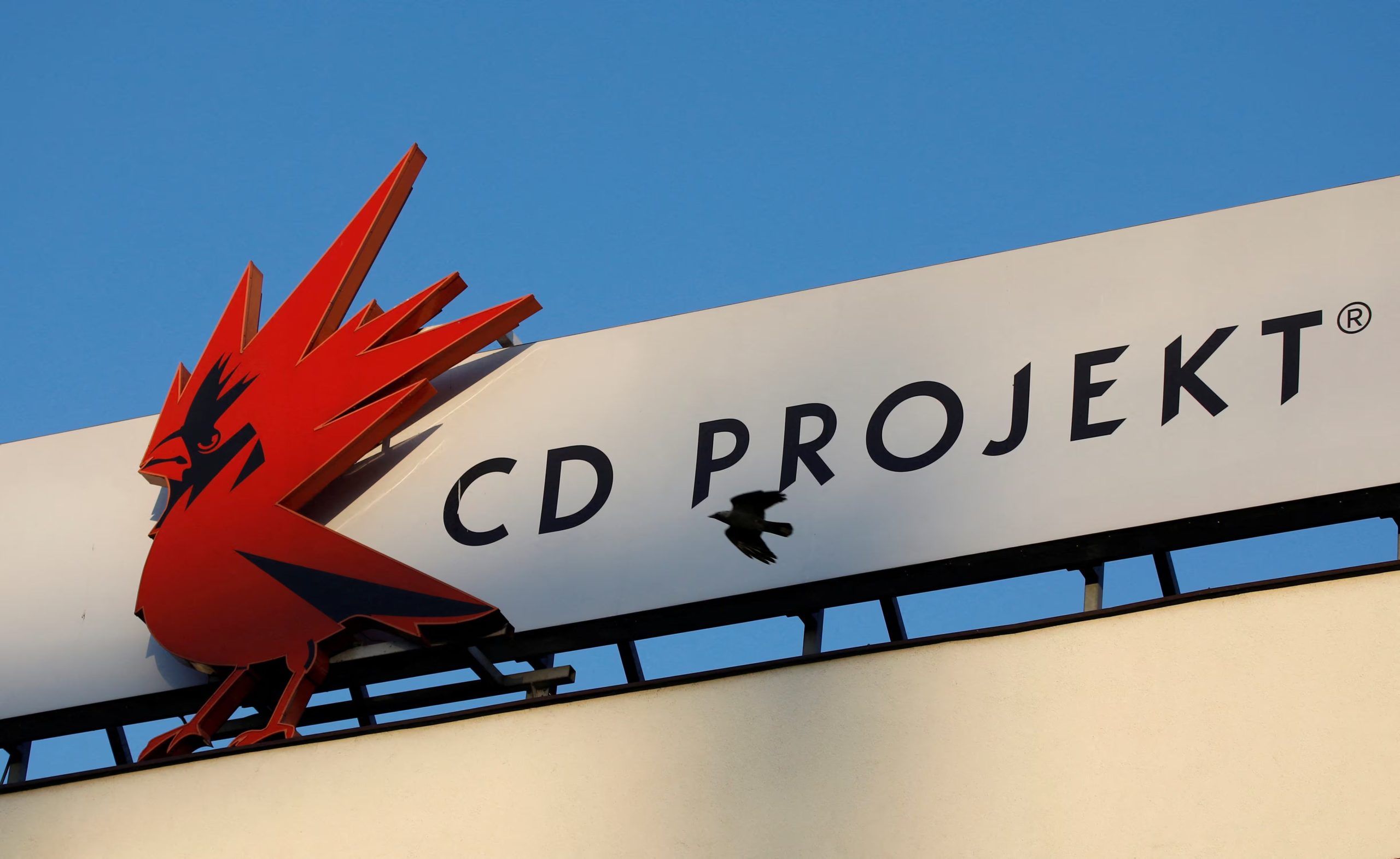 FILE PHOTO: A bird flies in front of the Cd Projekt logo at its headquarters in Warsaw, Poland January 21, 2020. Picture taken January 21, 2020. REUTERS/Kacper Pempel/File Photo