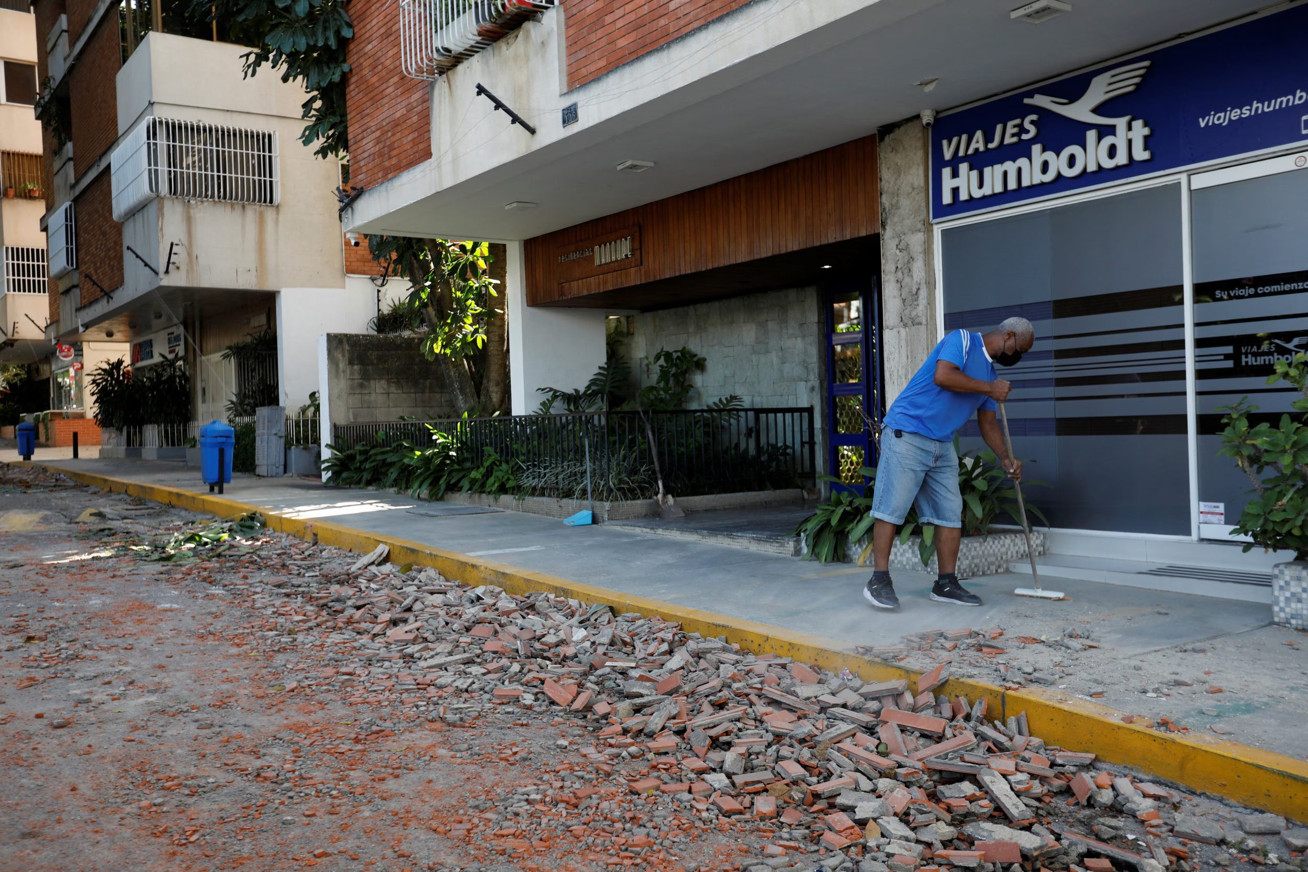 A man cleans debris from the street after earthquakes hit the country, in Caracas, Venezuela, June 25, 2026. REUTERS/Fausto Torrealba