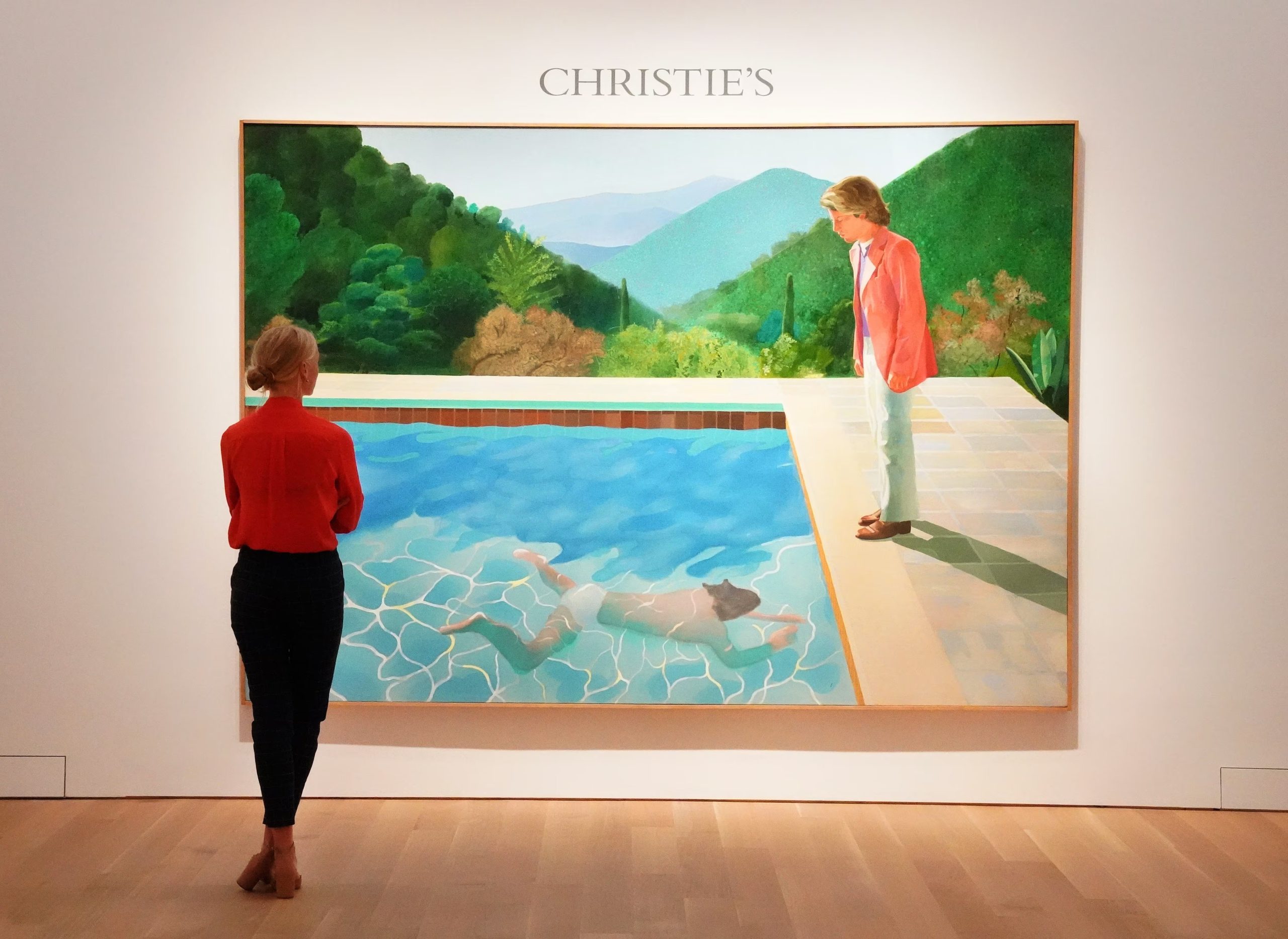 “Portrait of an Artist (Pool with Two Figures)” alcanza 90,3 millones de dólares y define un hito para el arte contemporáneo. (Photo by TIMOTHY A. CLARY / AFP)