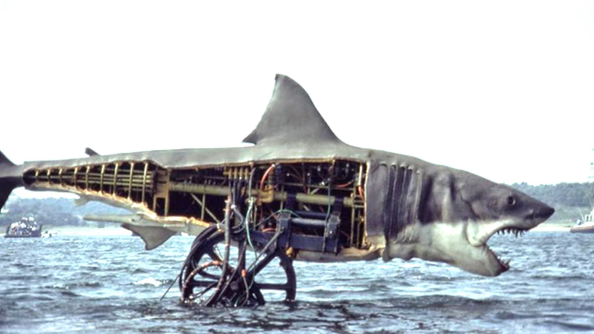 Las fallas del tiburón mecánico llevaron a Spielberg a mostrar menos al animal y a reforzar la tensión con sugestión, edición y sonido