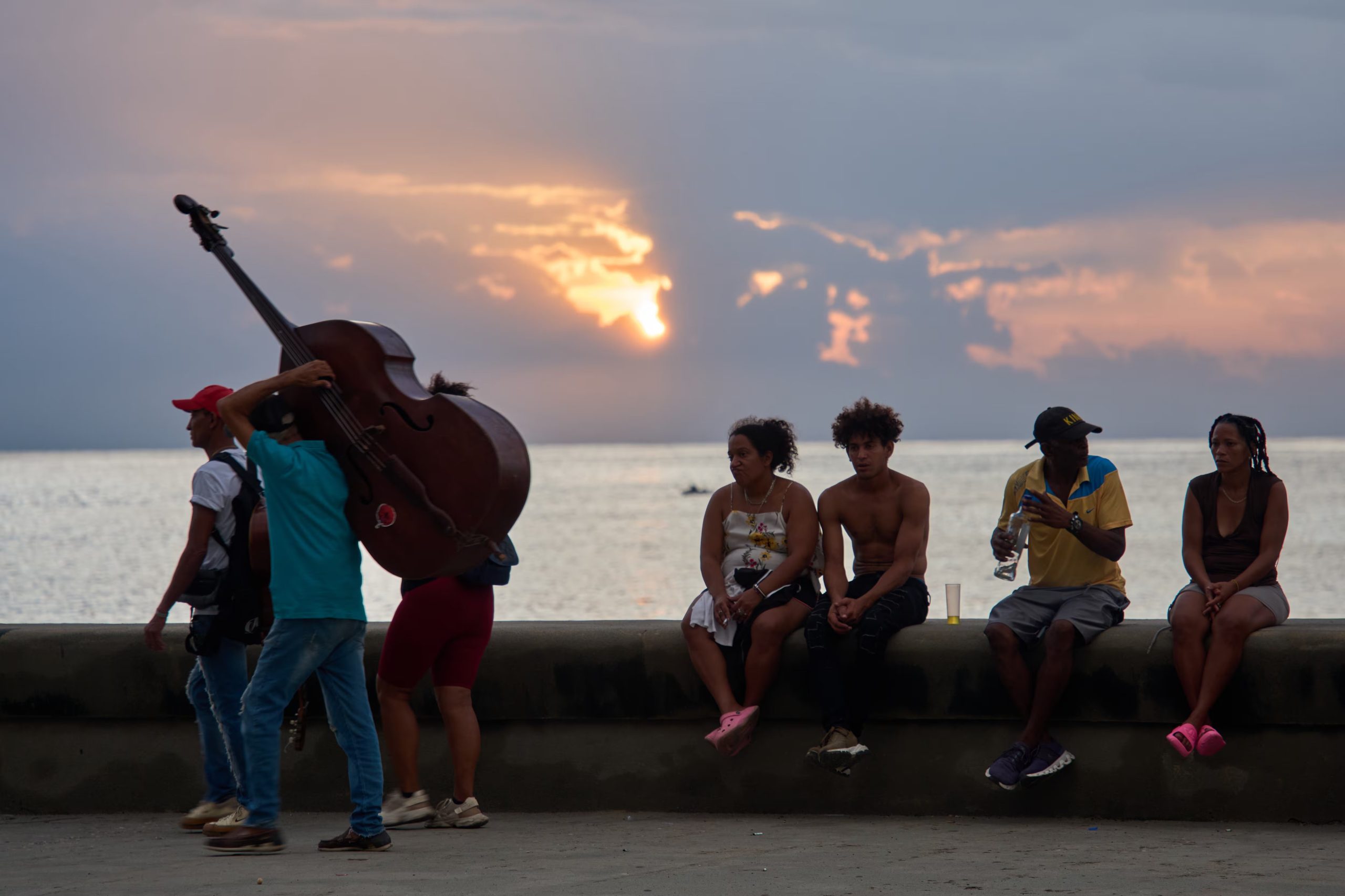 Personas pasan el tiempo sentadas en el muro del Malecón durante un apagón en La Habana (Foto AP/Ramón Espinosa)