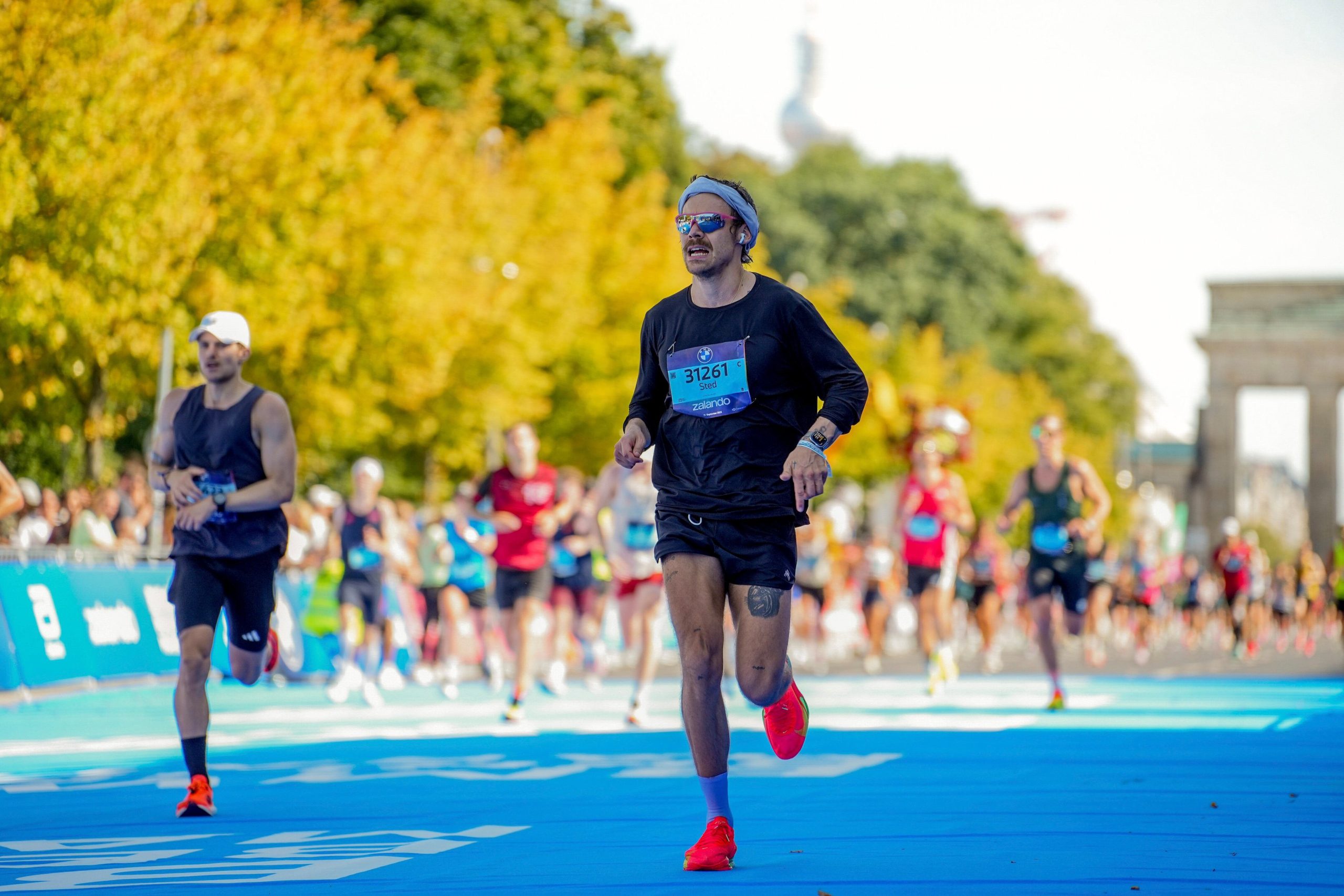 Harry Styles, en el centro, compite en el Maratón de Berlín en Berlín, Alemania, el 21 de septiembre de 2025. (Sportograf via AP)