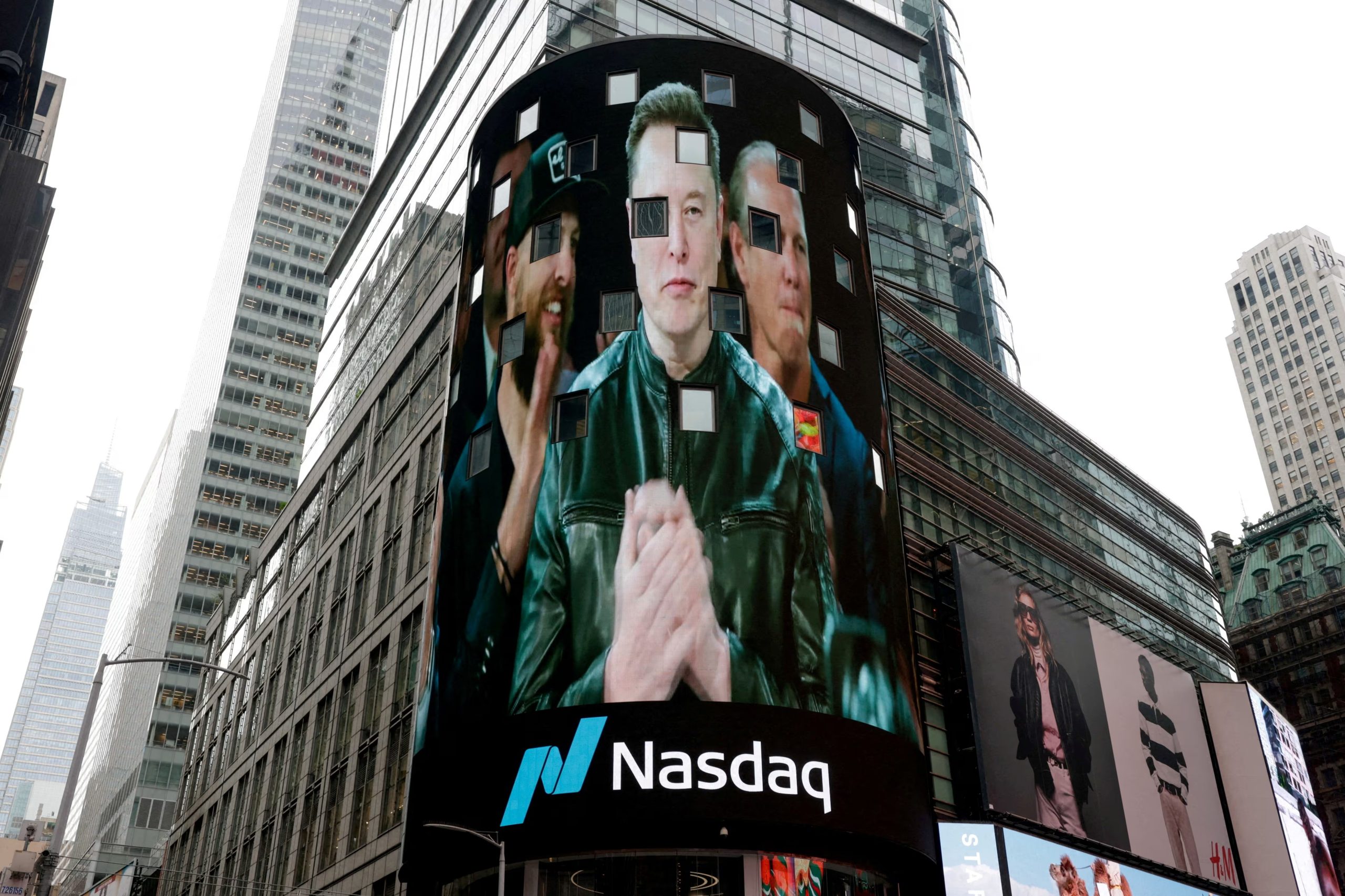 FILE PHOTO: A live feed shows SpaceX CEO Elon Musk on the day of SpaceX's initial public offering (IPO) at the Nasdaq MarketSite, in New York City, U.S., June 12, 2026. REUTERS/Jeenah Moon/File Photo