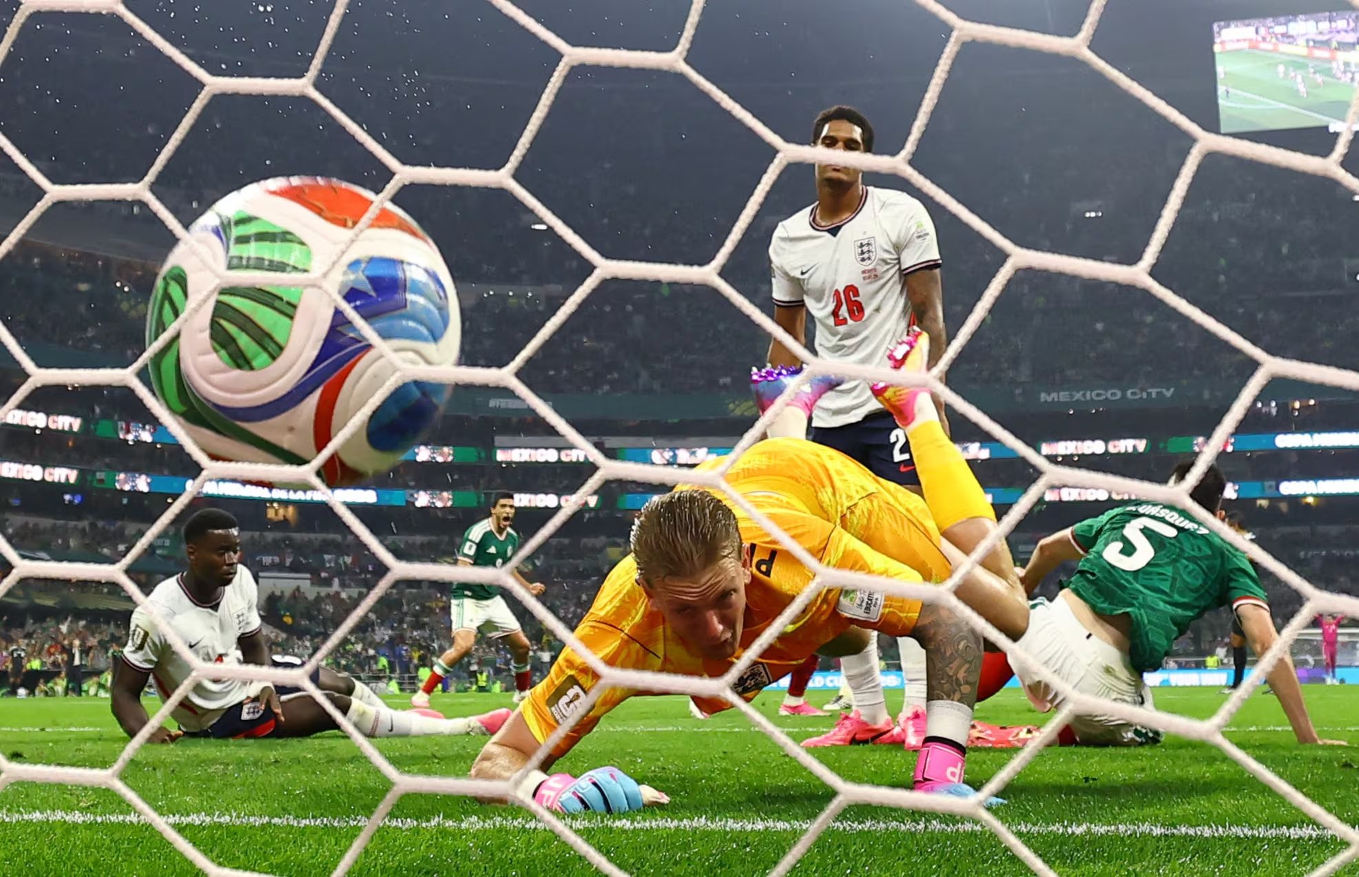 Soccer Football - FIFA World Cup 2026 - Round of 16 - Mexico v England - Estadio Azteca, Mexico City, Mexico - July 5, 2026 Mexico's Julian Quinones scores their first goal past England's Jordan Pickford REUTERS/Paul Childs