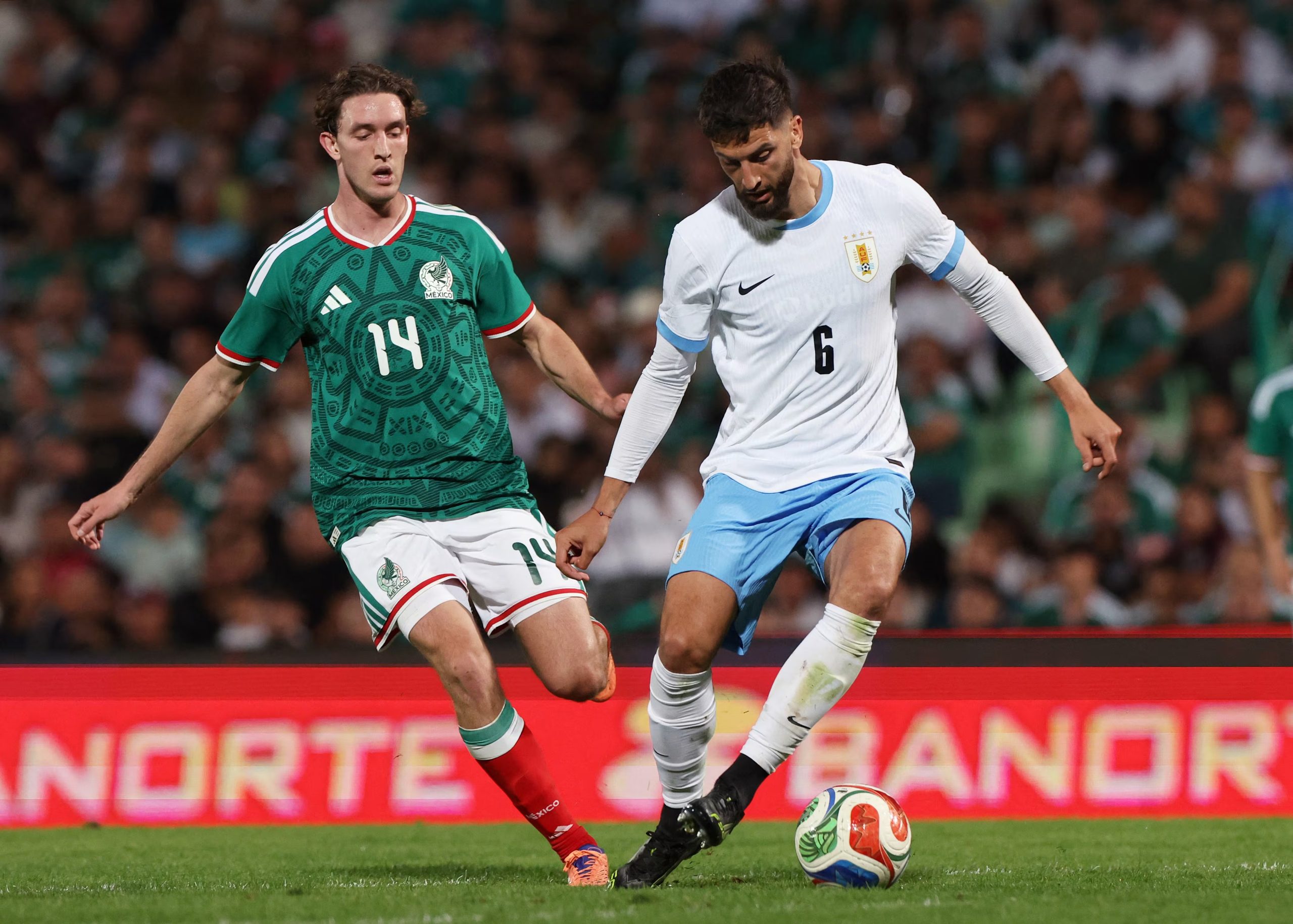 Soccer Football - International Friendly - Mexico v Uruguay - Estadio Corona, Torreon, Mexico - November 15, 2025 Uruguay's Rodrigo Bentancur in action with Mexico's Marcel Ruiz REUTERS/Henry Romero