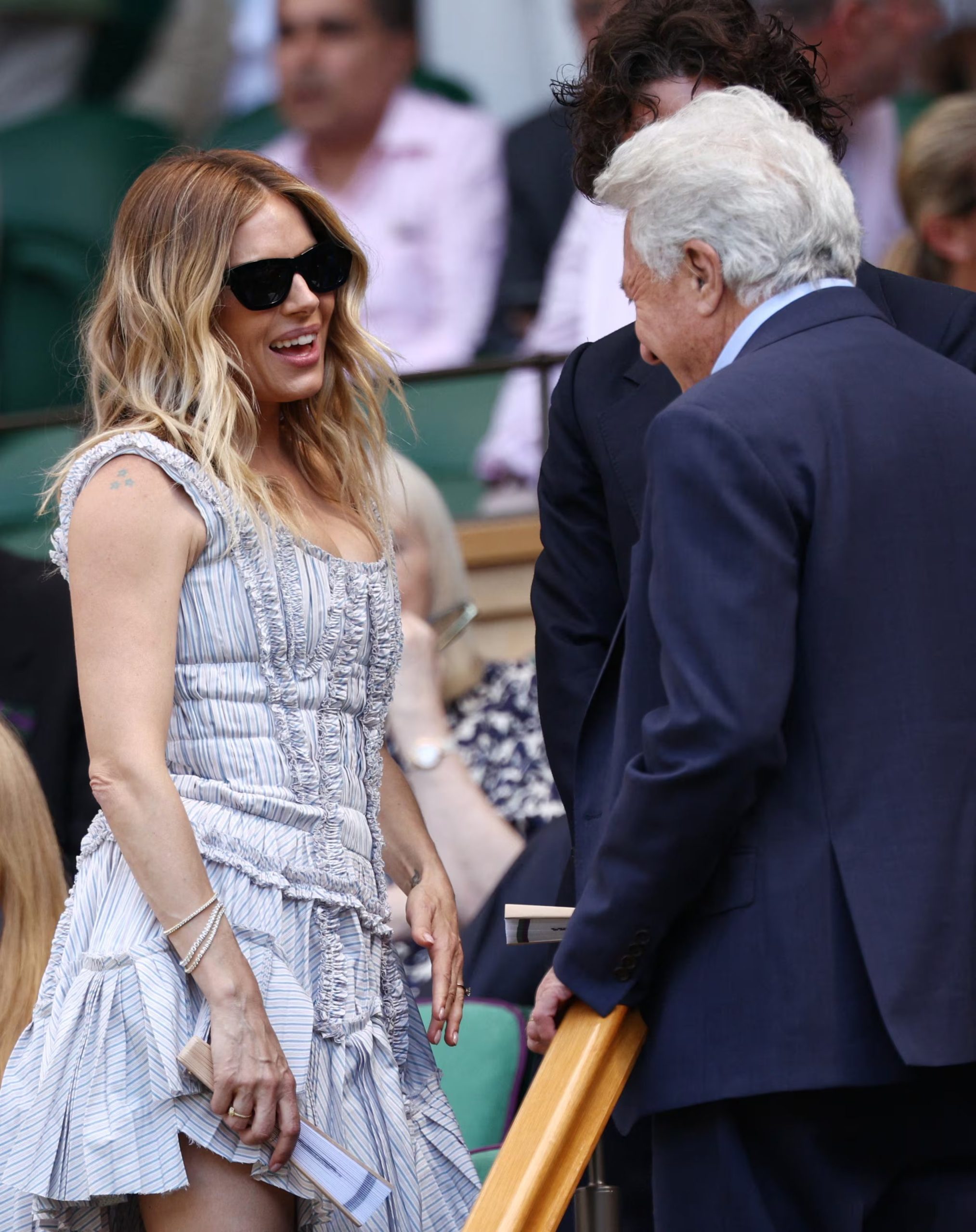 Sienna Miller apuesta por rayas azules y blancas con volantes y frunces, con pulseras plateadas y ondas marcadas