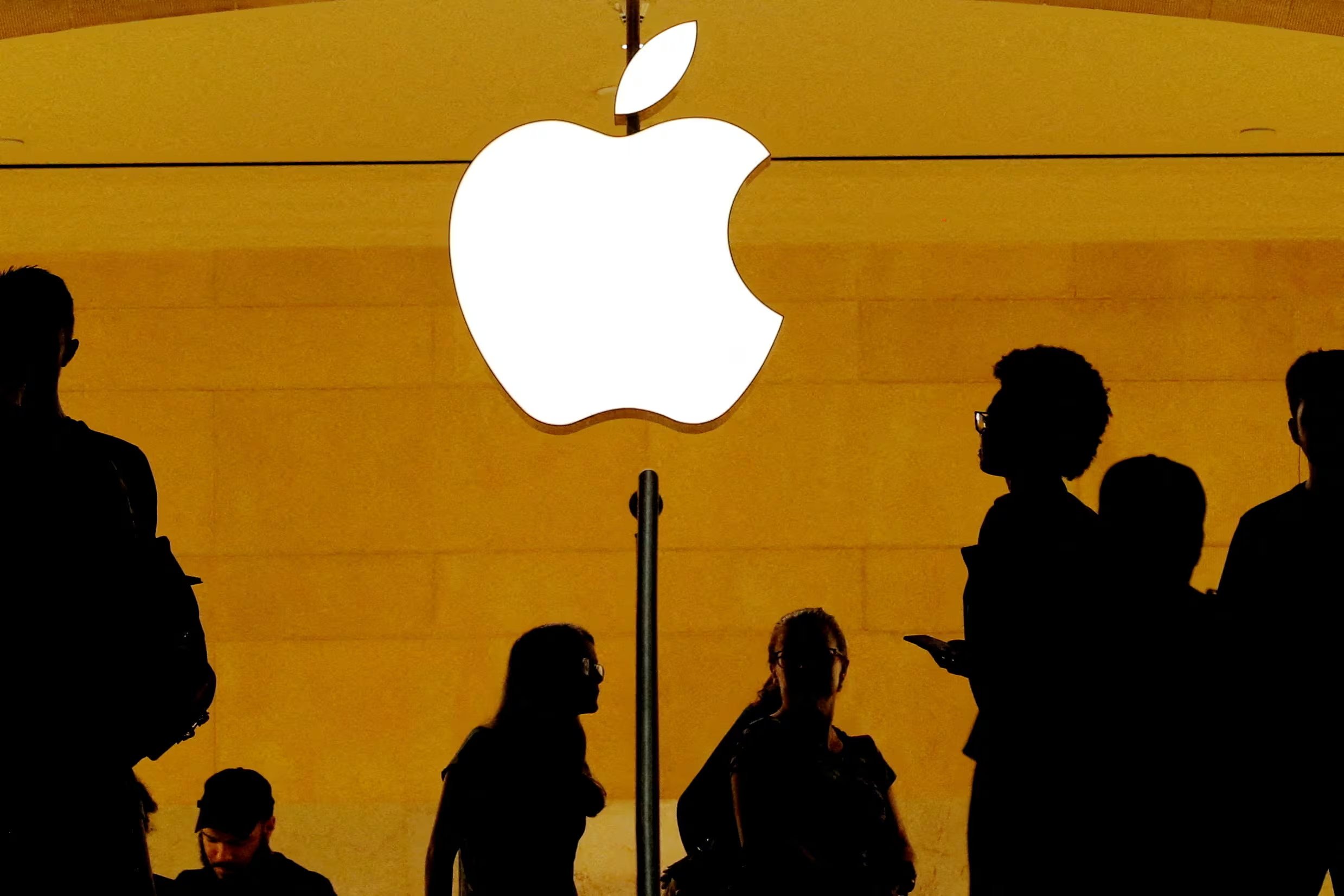 FILE PHOTO: Customers walk past an Apple logo inside of an Apple store at Grand Central Station in New York, U.S., August 1, 2018. REUTERS/Lucas Jackson/File Photo