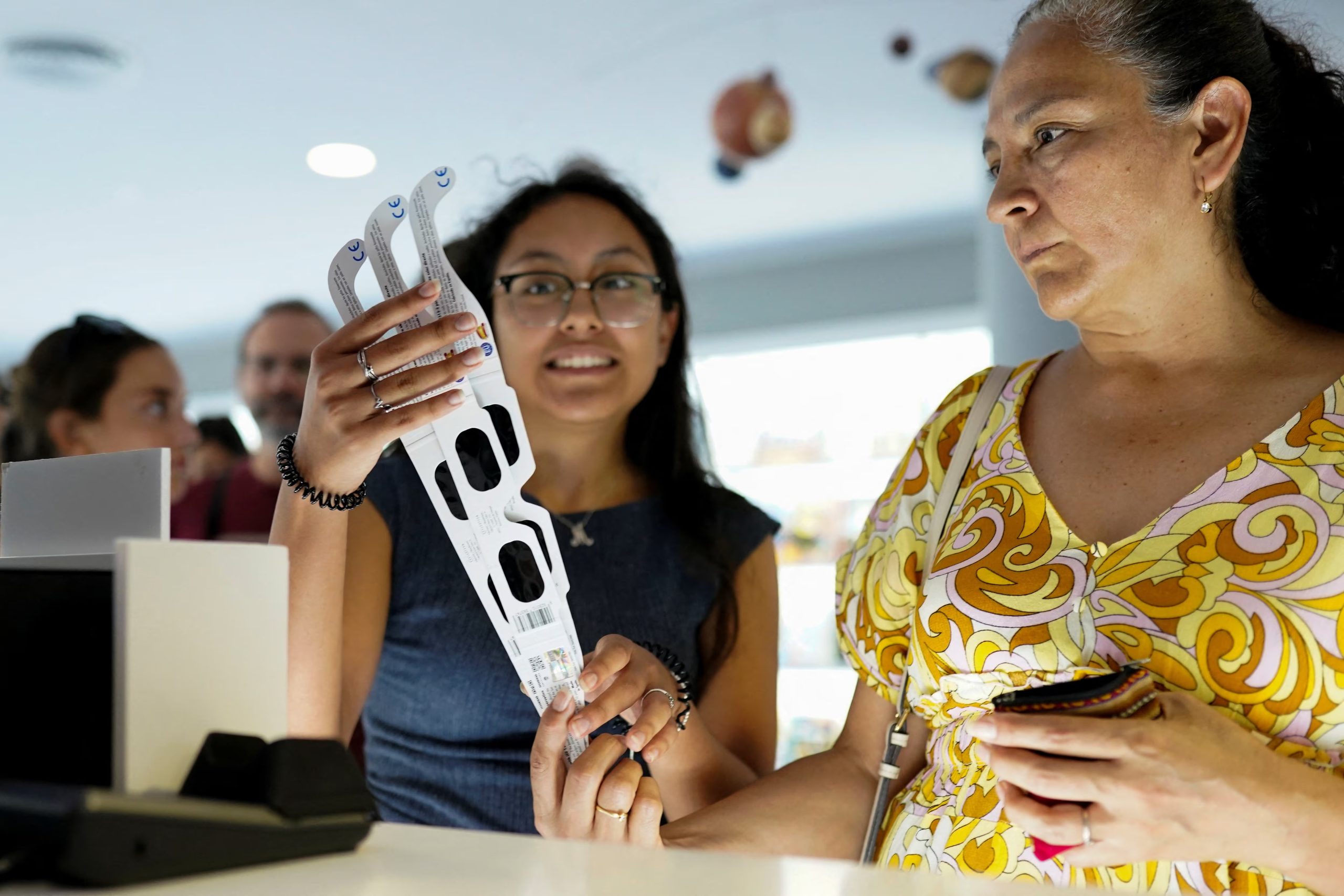 A person buys eclipse-viewing glasses in Madrid’s Planetarium store as the city counts down to the solar eclipse on August 12, in Madrid, Spain, August 9, 2026. REUTERS/Ana Beltran