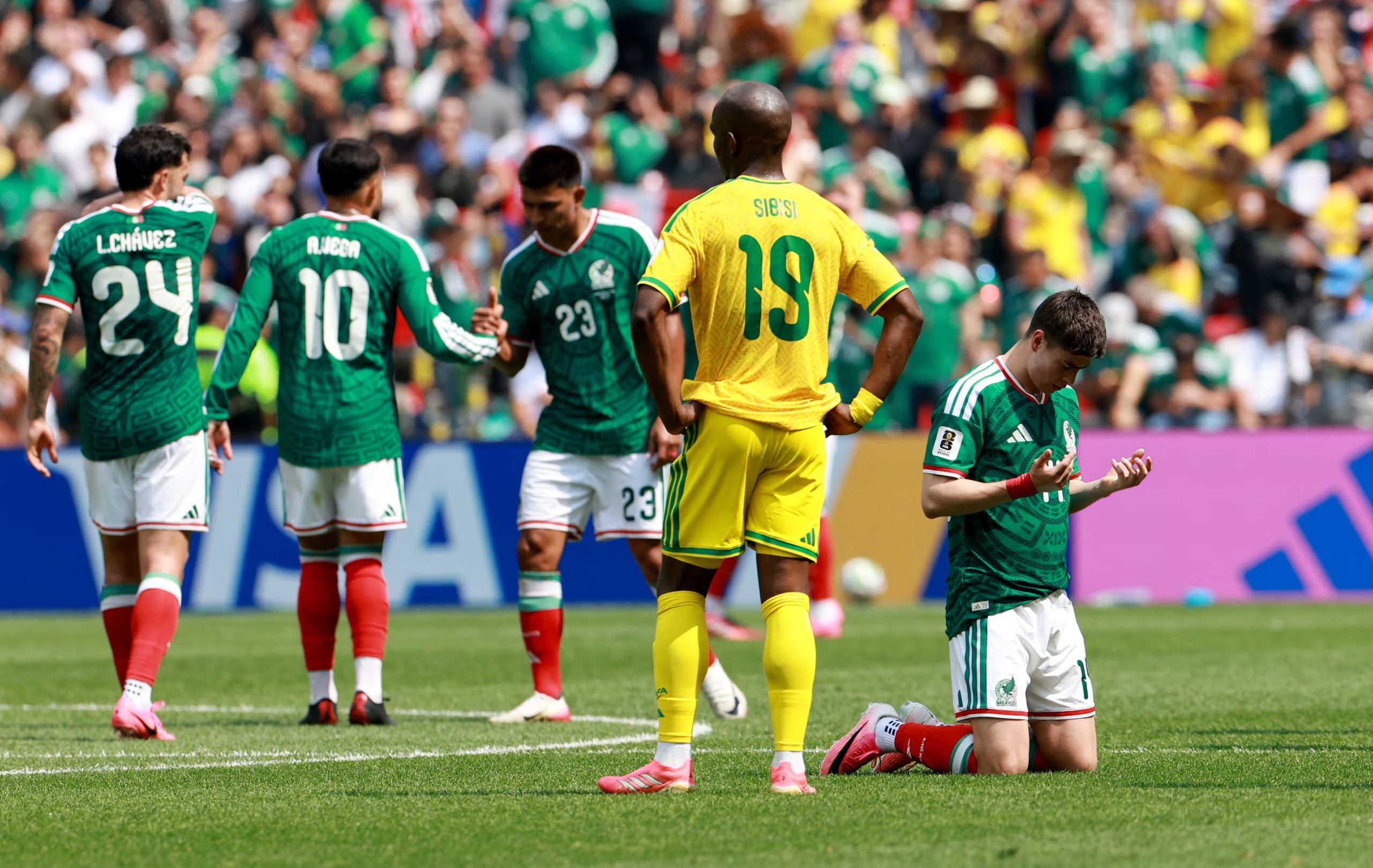 Soccer Football - FIFA World Cup 2026 - Group A - Mexico v South Africa - Estadio Azteca, Mexico City, Mexico - June 11, 2026 Mexico's Armando Gonzalez reacts as South Africa's Nkosinathi Sibisi looks dejected after the match REUTERS/Henry Romero