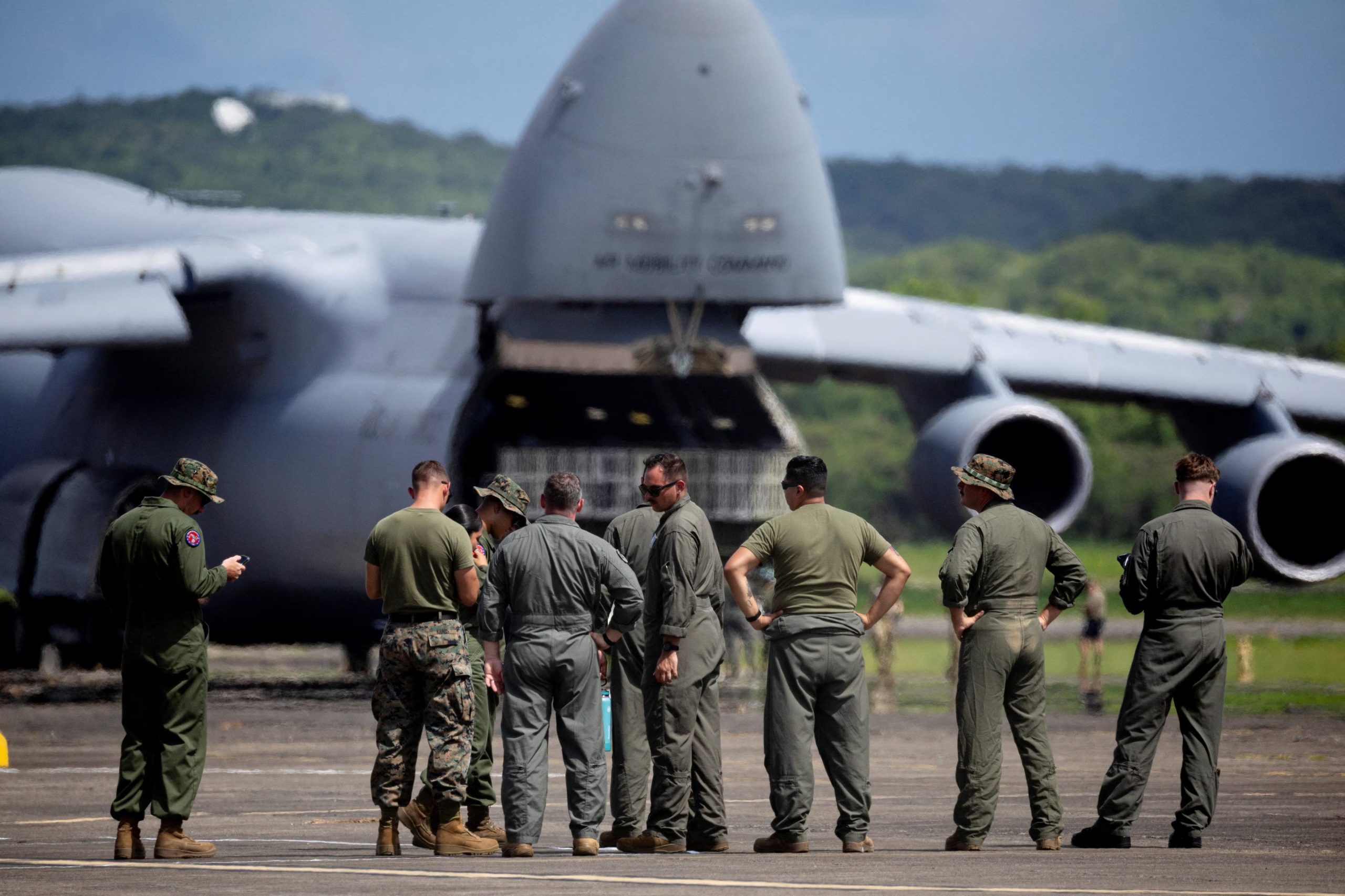 Military personnel stand near a U.S. Air Force C5 Globemaster on the former Roosevelt Roads military base in Ceiba, Puerto Rico, September 12, 2025. REUTERS/Ricardo Arduengo
