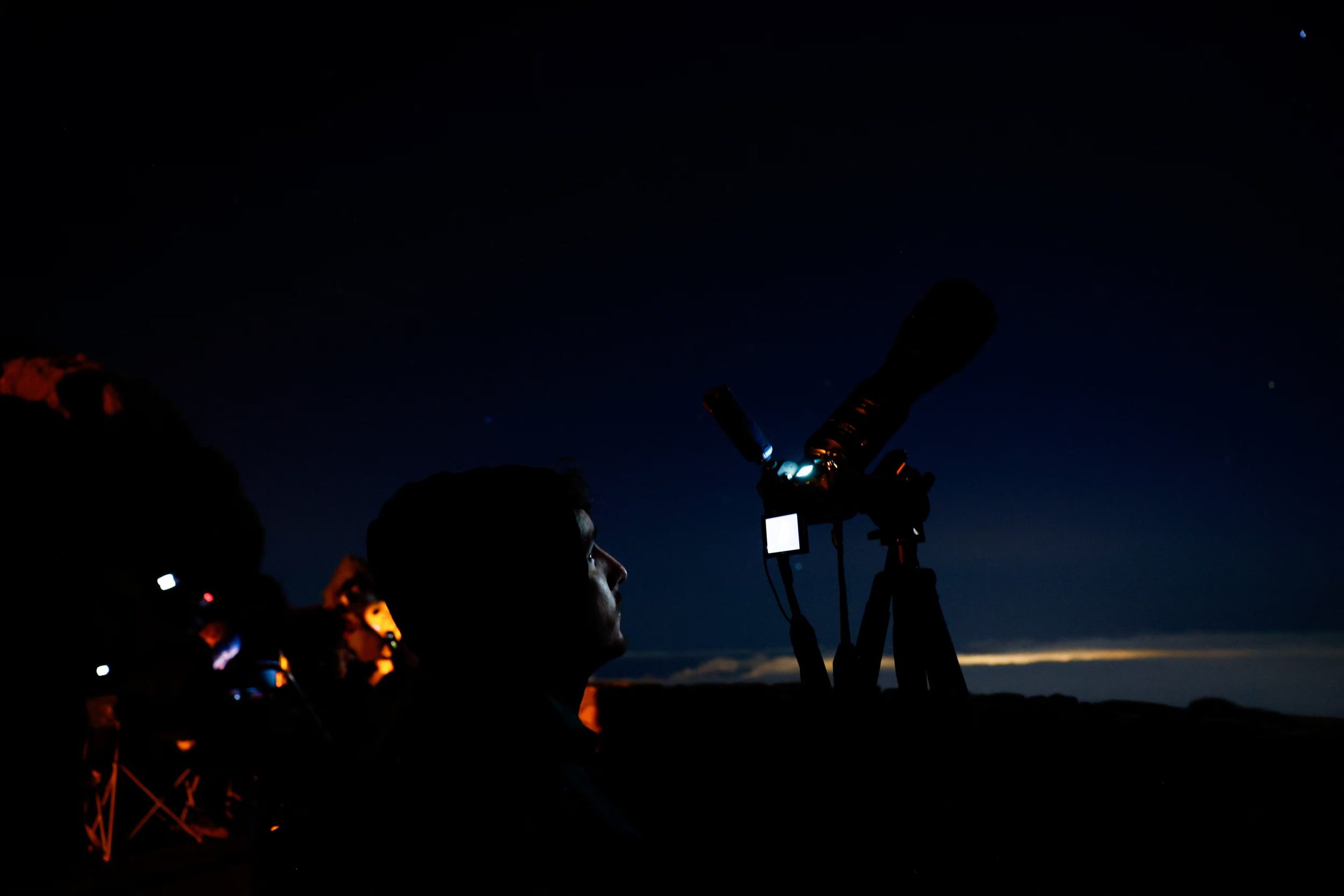 Photojournalist Eduardo Robayna photographs the partial lunar eclipse from Pico De Las Nieves on the island of Gran Canaria, Spain, August 28, 2026. REUTERS/Borja Suarez
