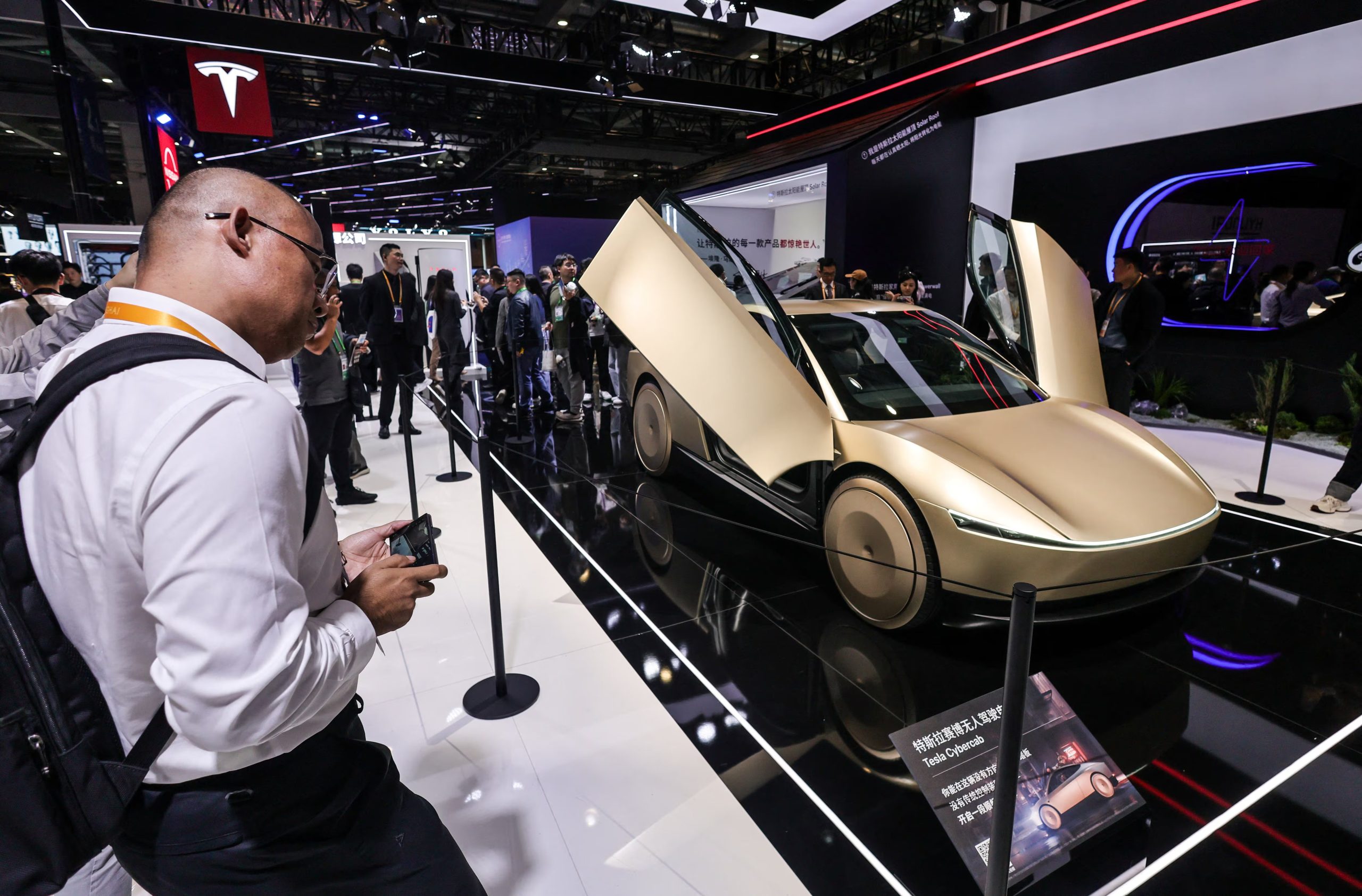 A man looks at Tesla Cybercab displayed at the Tesla company’s booth at the 8th China International Import Expo (CIIE) in Shanghai, China, November 6, 2025.REUTERS/Maxim Shemetov