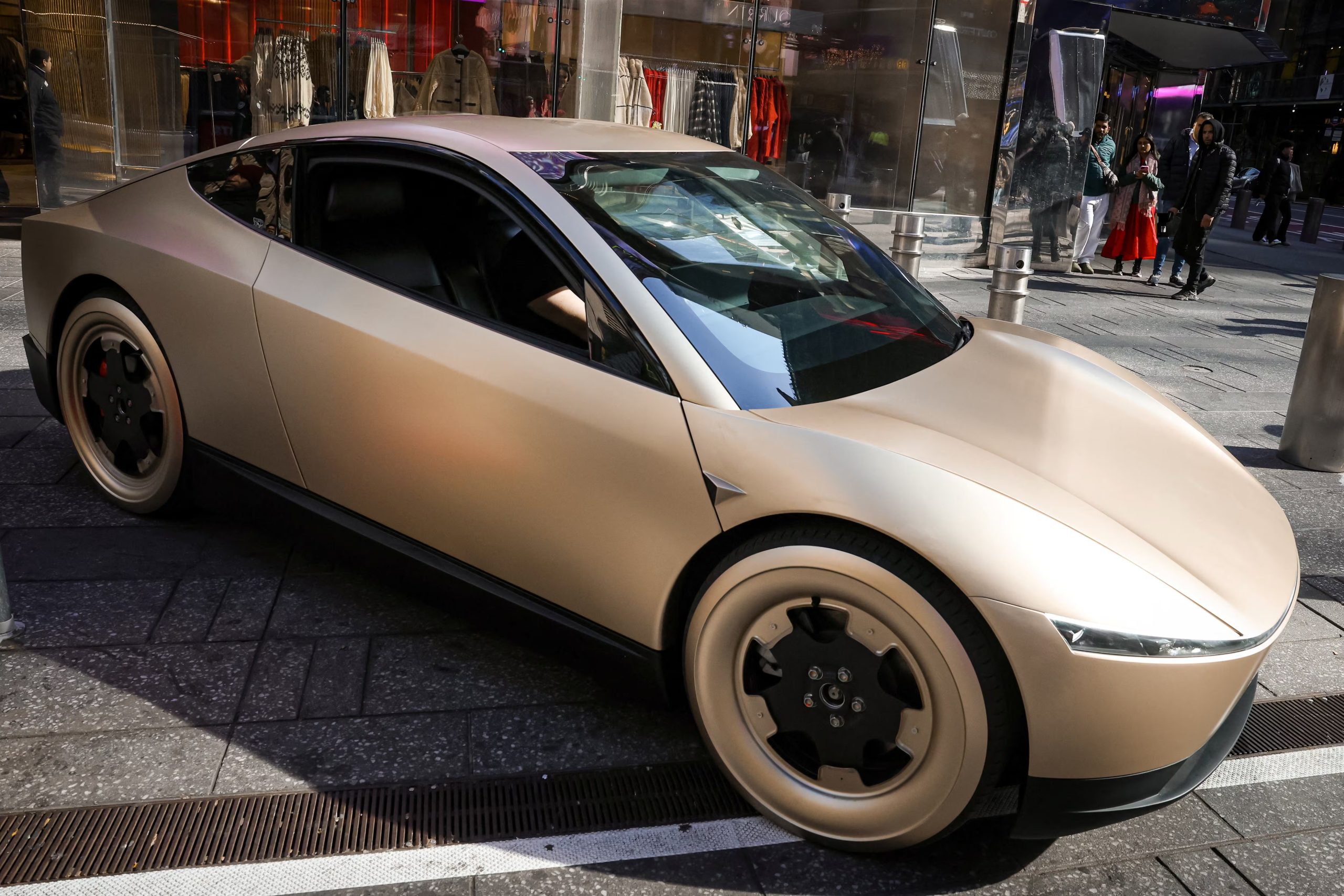 A Tesla Cybercab drives on the sidewalk during an appearance outside the Nasdaq Market site in New York City, U.S., October 27, 2025. REUTERS/Brendan McDermid