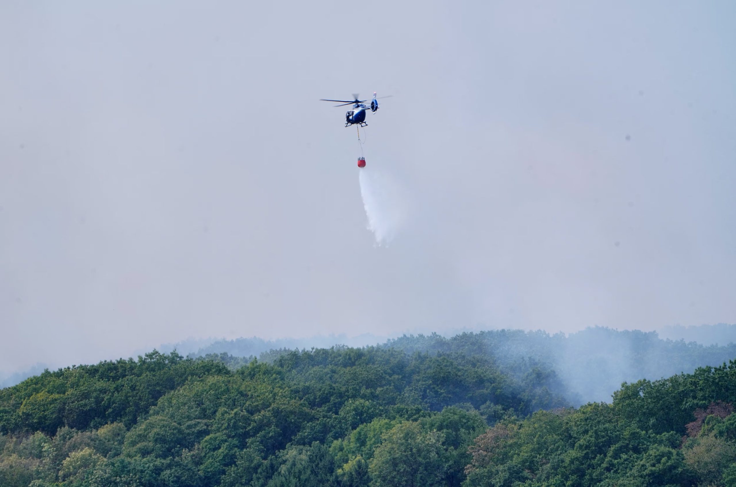Un helicóptero sobrevuela la zona mientras el humo se eleva cerca de un área residencial (REUTERS/Timm Reichert)