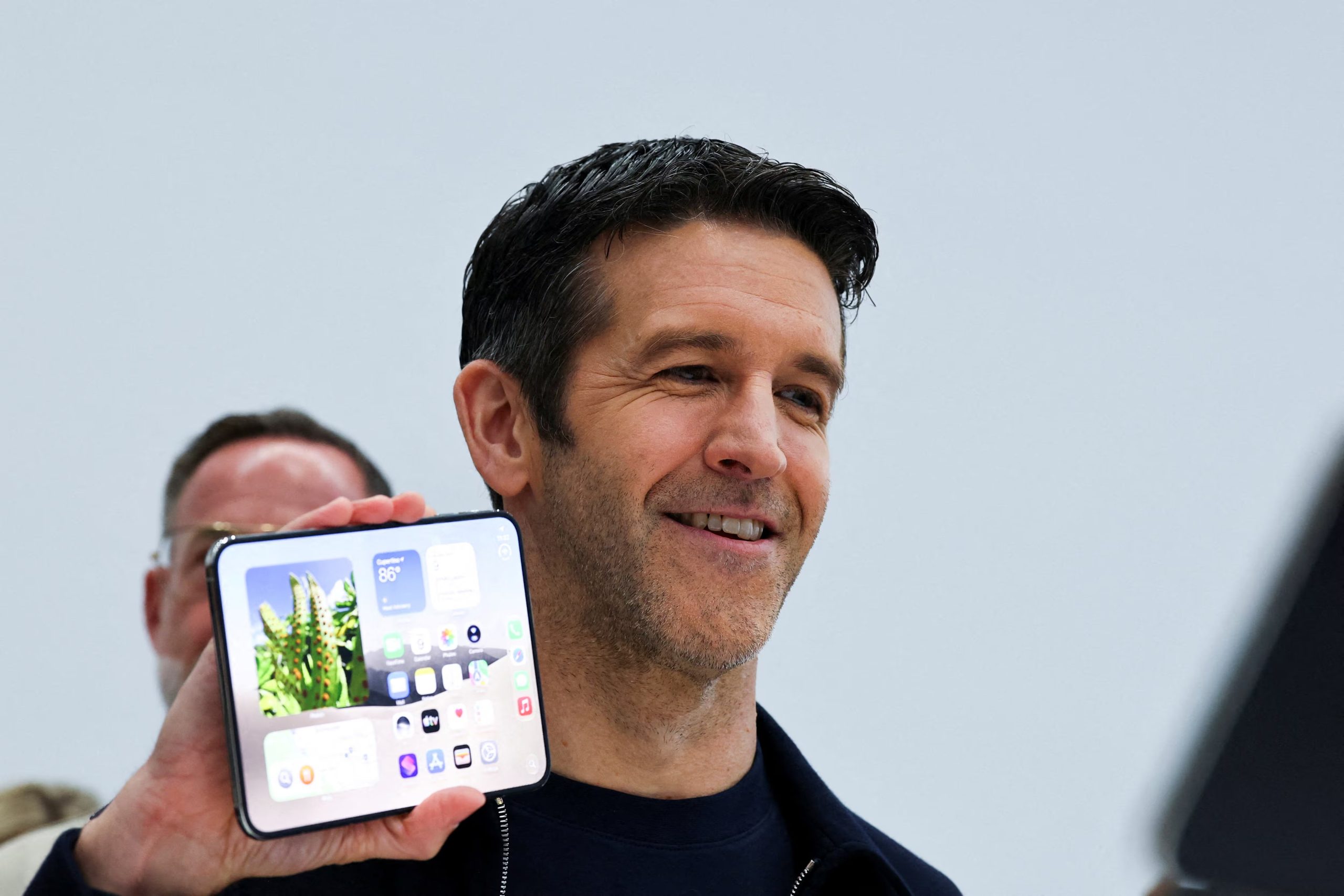 FILE PHOTO: New Apple CEO John Ternus holds the new foldable iPhone Duo during Apple's event at the Steve Jobs Theater in Cupertino, California, U.S. September 9, 2026. REUTERS/Carlos Barria/File Photo