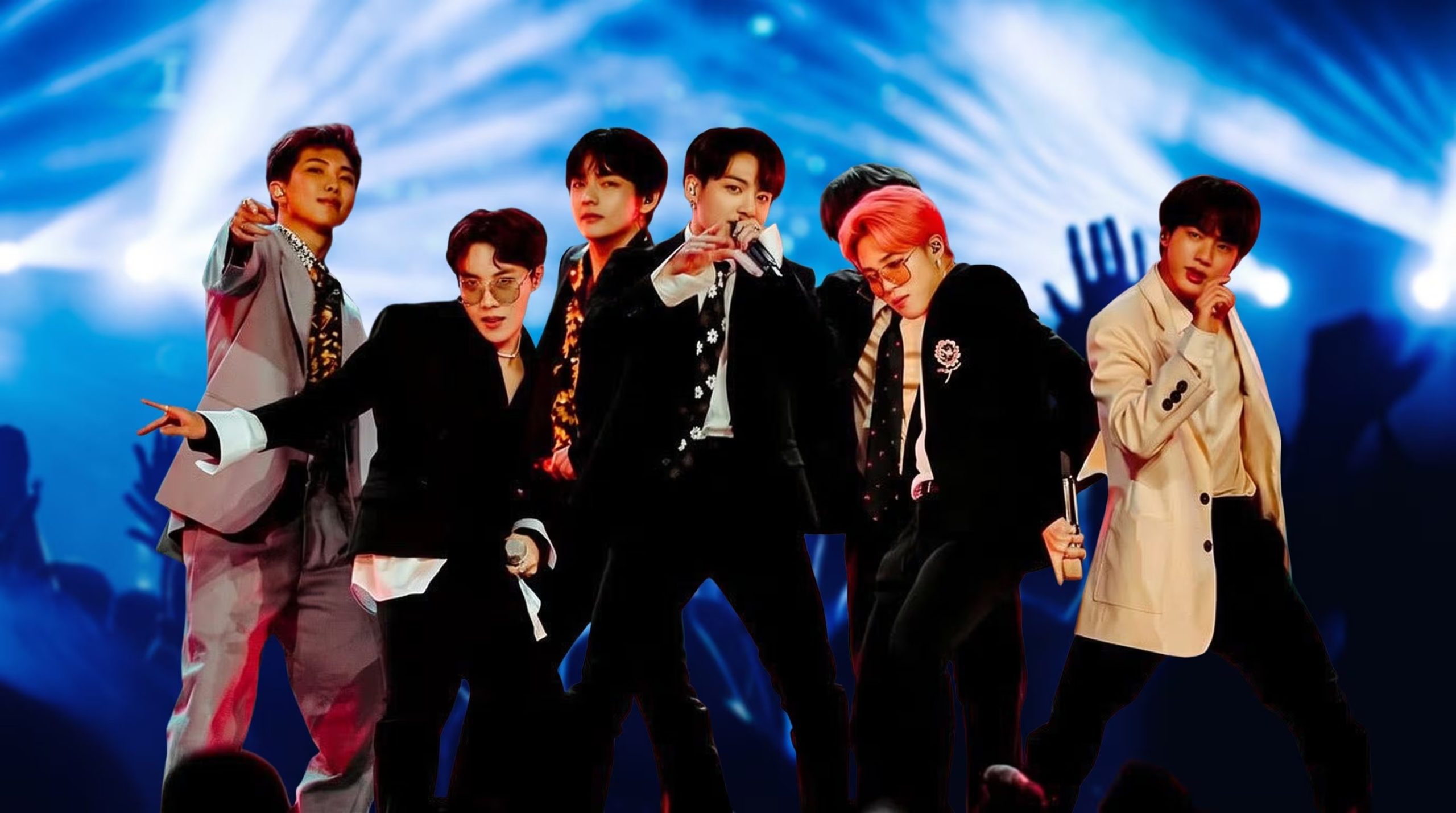 Los integrantes del grupo surcoreano BTS realizan una presentación en vivo sobre un escenario iluminado con luces azules. (Imagen Ilustrativa Infobae)